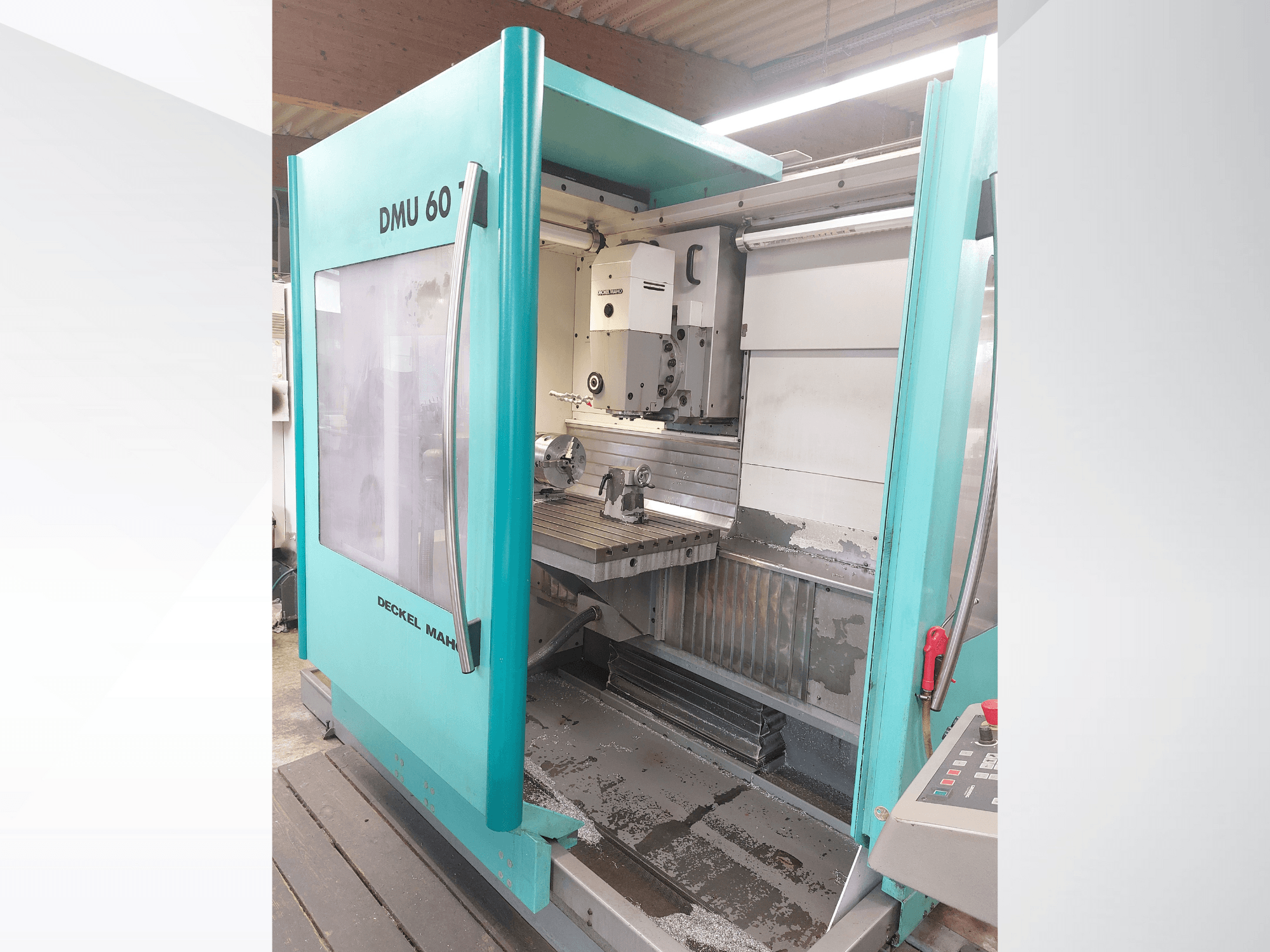Deckel MAHO DMU 60 CNC machine, front view. Features a visible control panel and milling table with a workpiece setup.