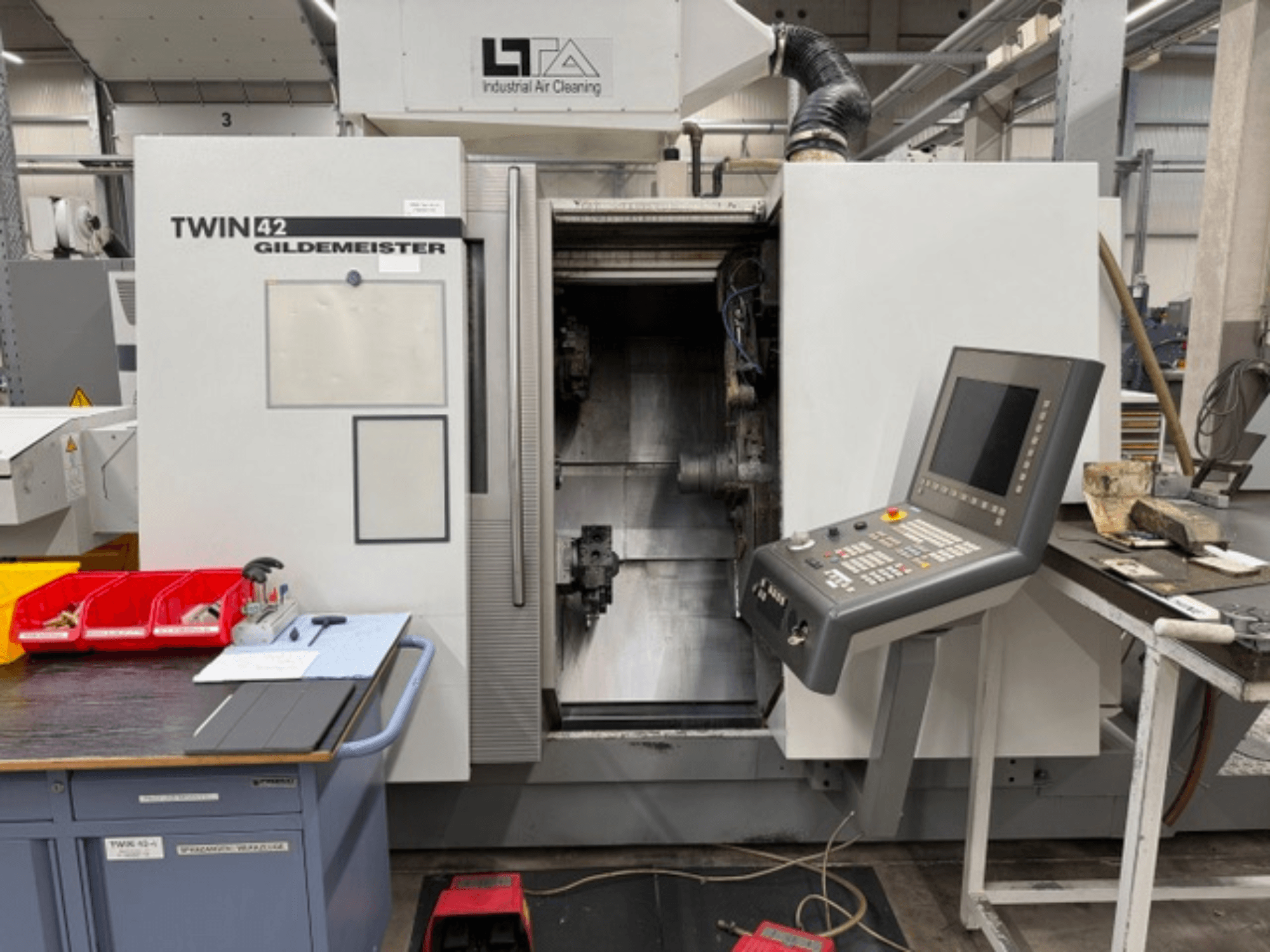 Gildemeister TWIN 42 horizontal turning machine, front view showing control panel and open work area.