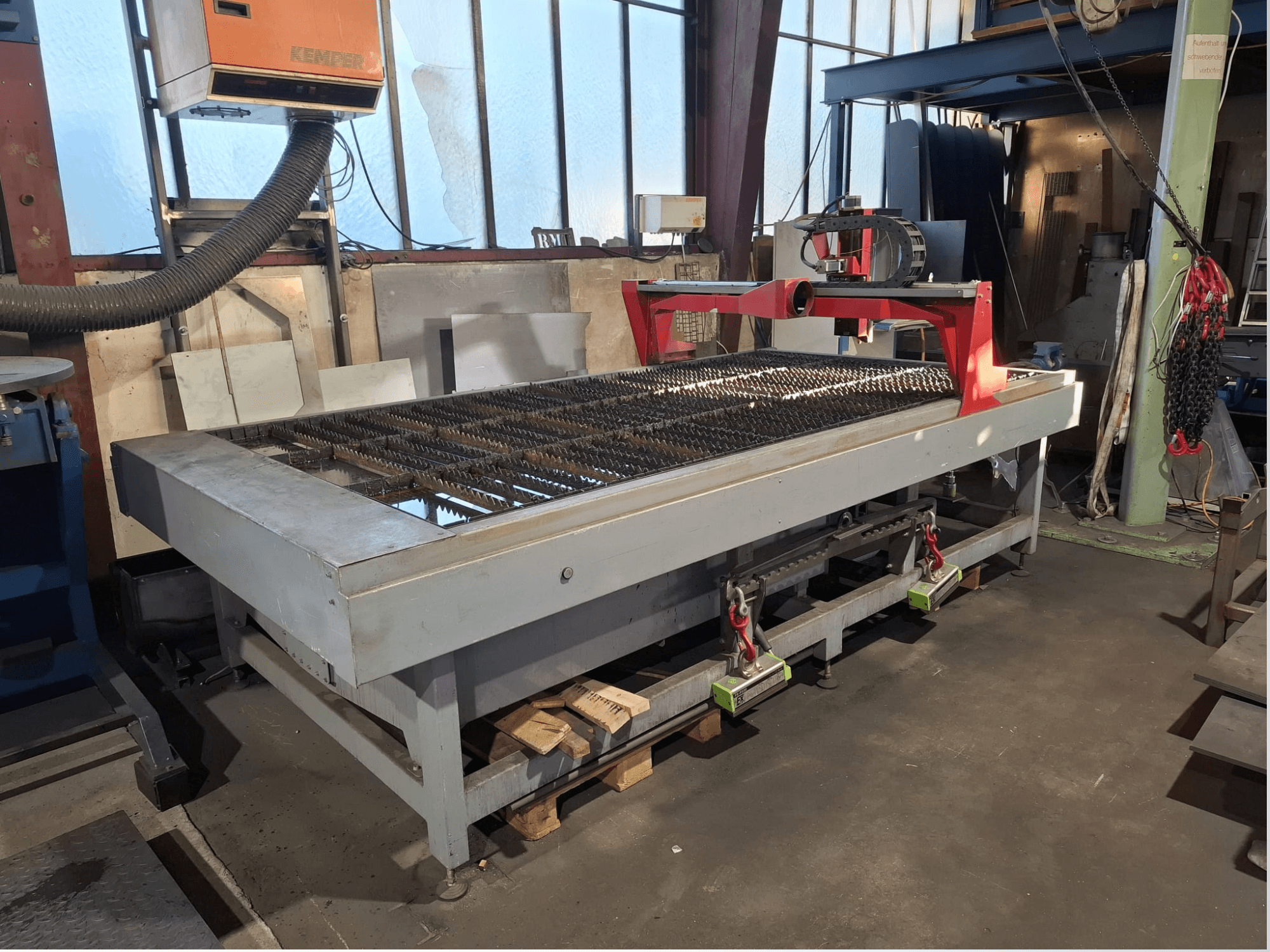 PLASMACUT 3015T plasma cutting machine shown in side view, featuring a large cutting table with metal slats and red frame.