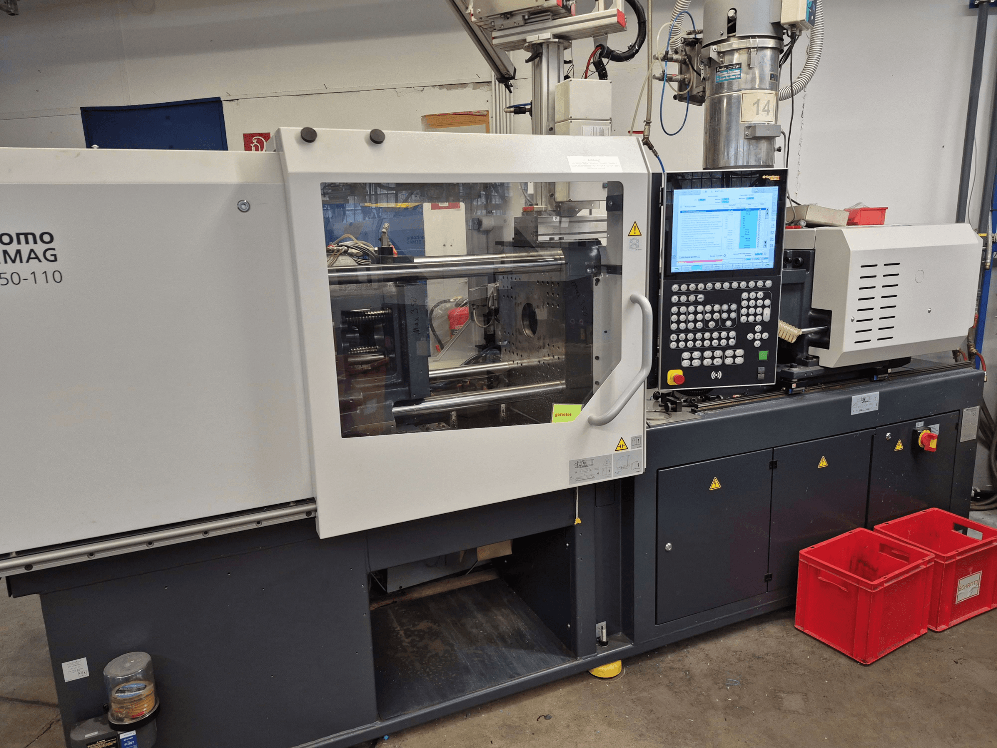 SUMITOMO SHI DEMAG Intelect 2 50/360-110 electrical injection moulding machine, side view with control panel and safety features visible.