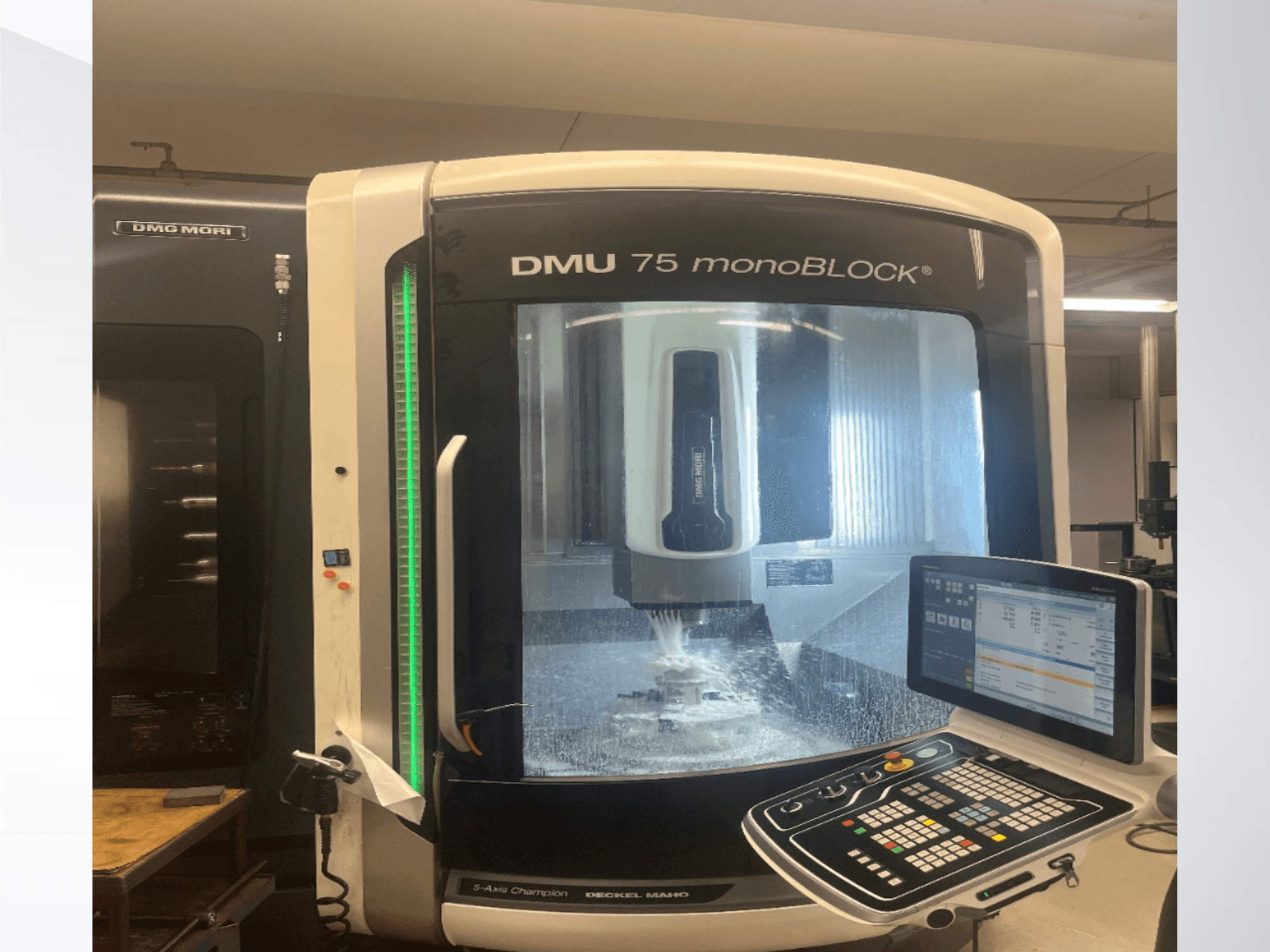 DMG MORI DMU 75 monoBLOCK universal machining center in front view, showcasing the control panel and milling area.