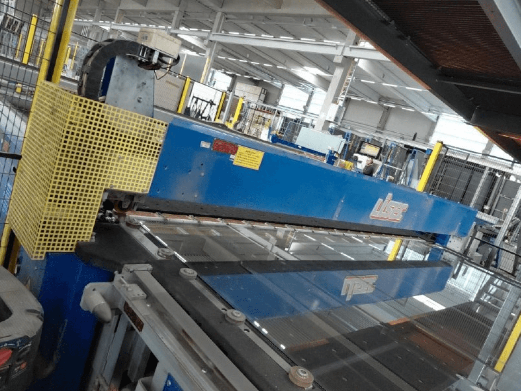 Front view of LISEC Combined VSG & Float Glass Cutting Line, featuring a blue cutting tool and protective mesh.