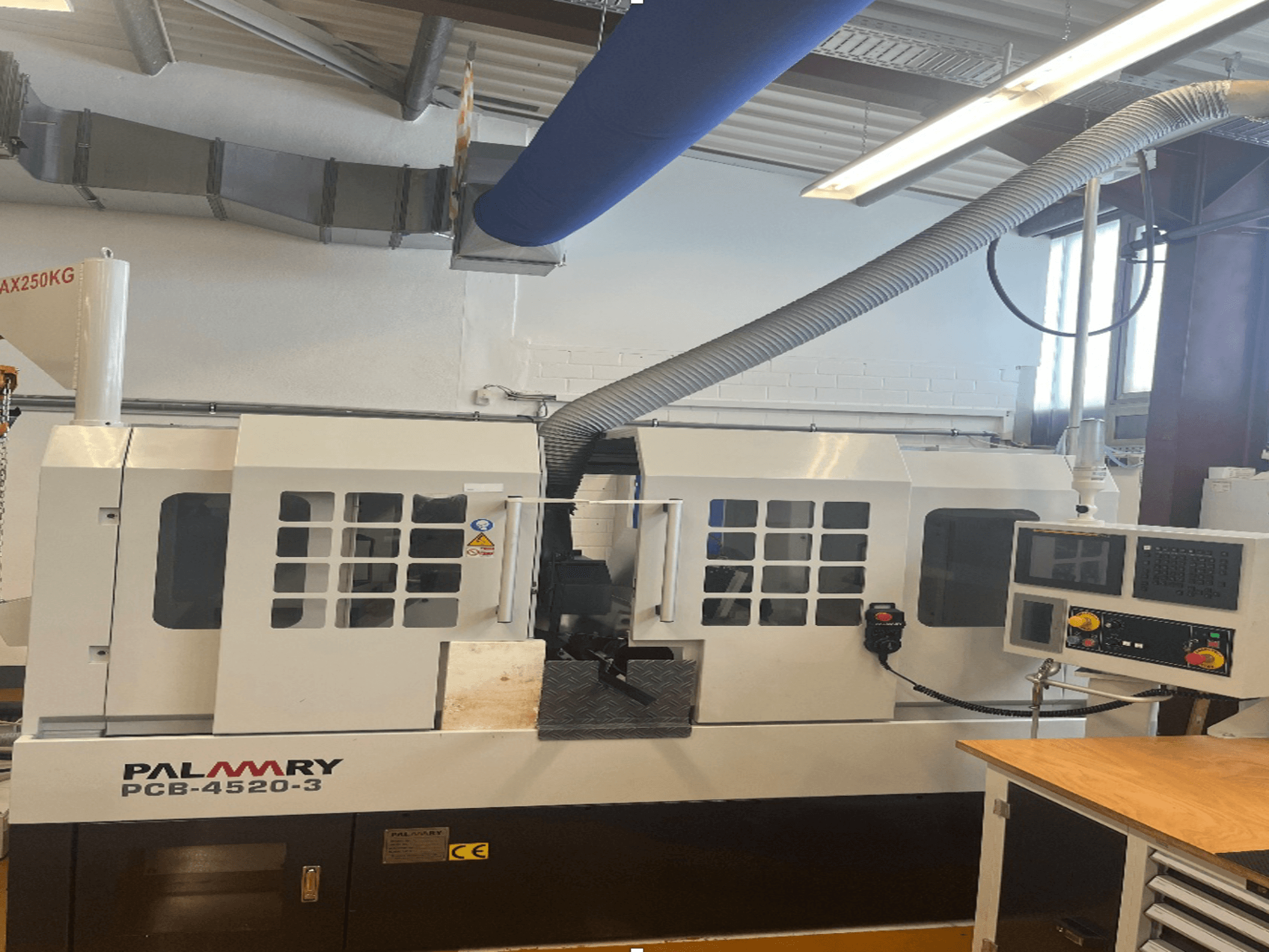 PALMARY PCB-4520-3 centerless grinding machine, front view, featuring control panel and dust extraction system.