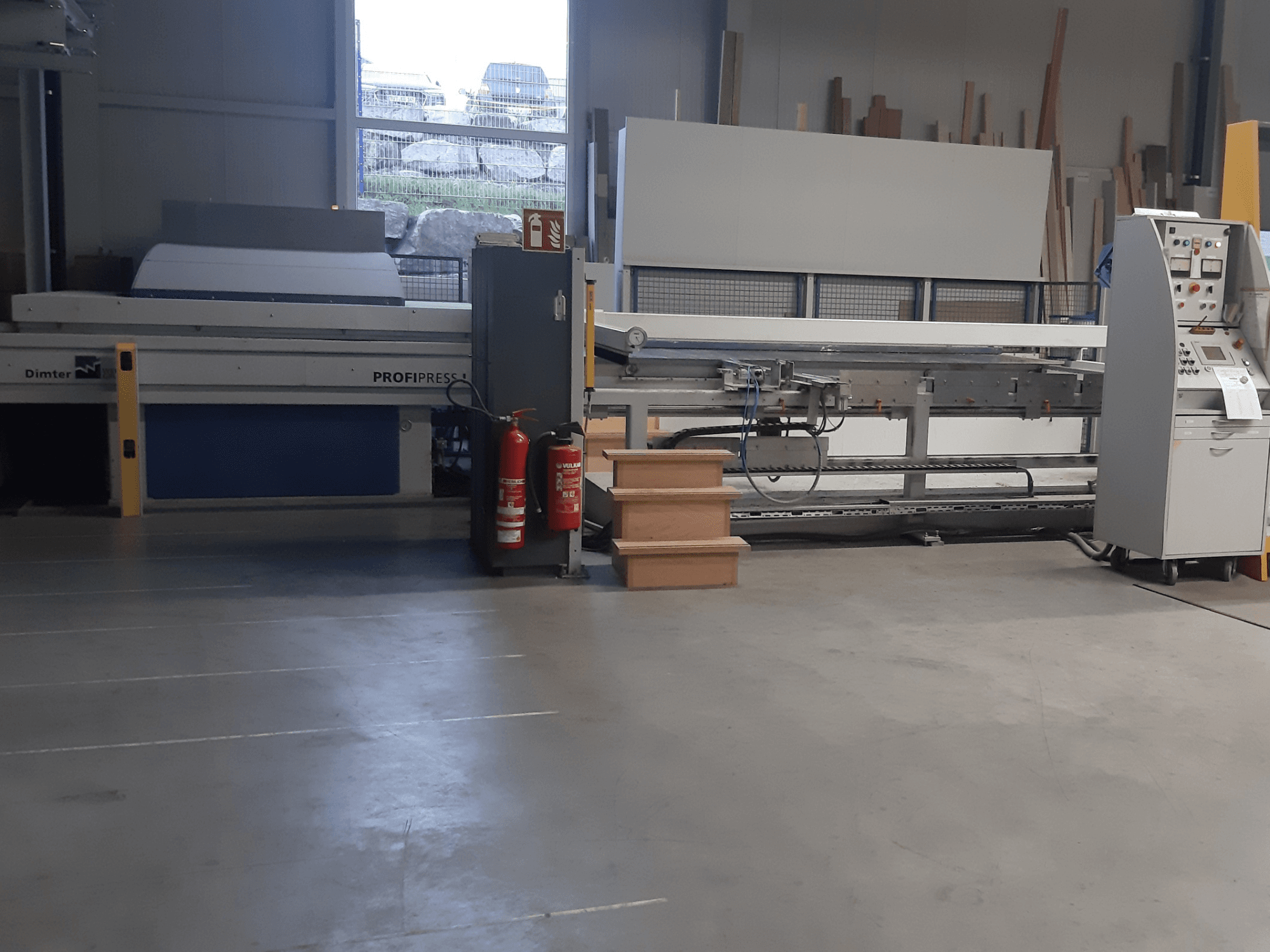 Dimter ProfiPress machine in a workshop, viewed from the front, with control panel and fire extinguishers nearby.