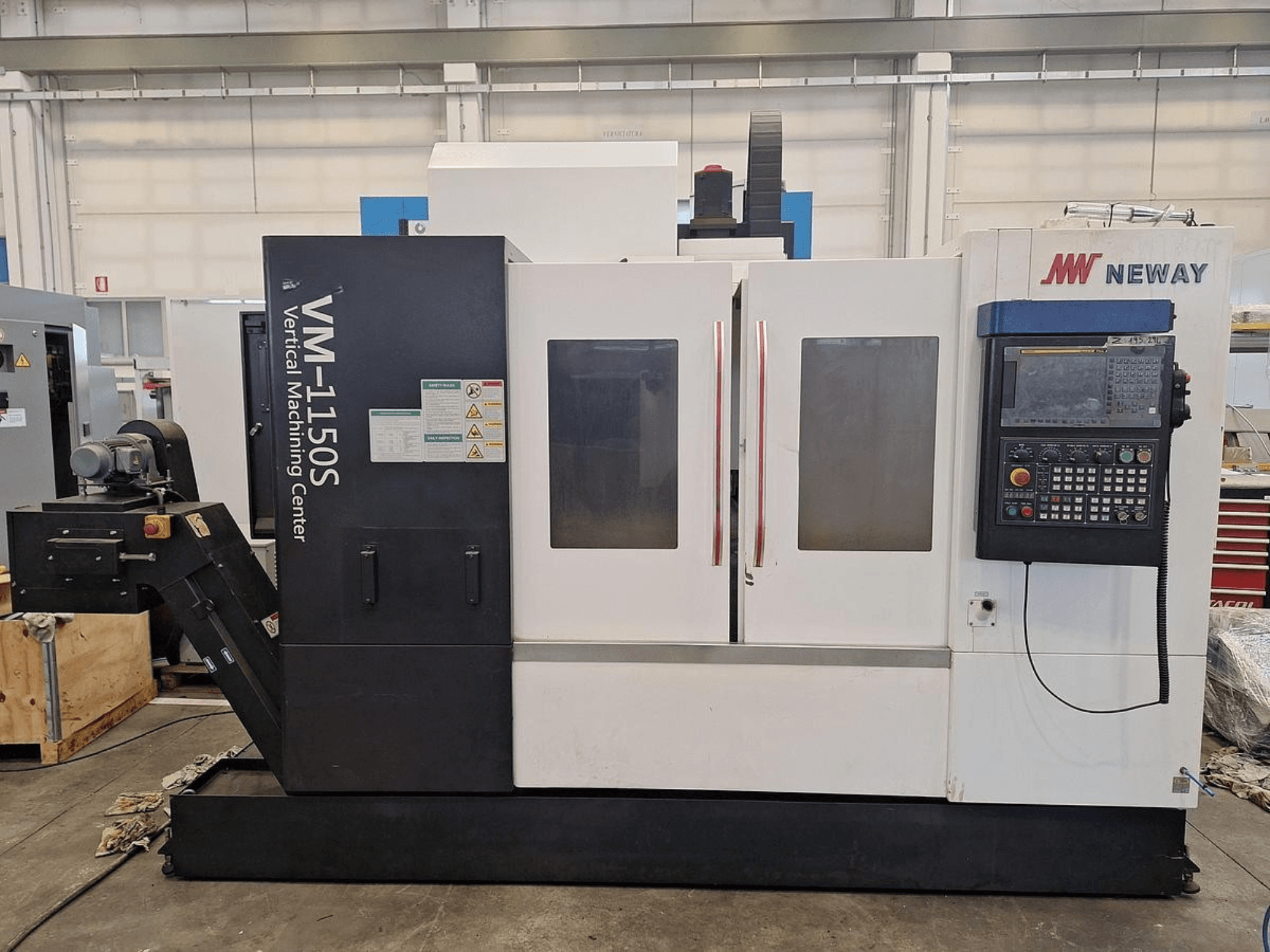 Neway VM-1150S vertical machining center, front view showing control panel, doors, and safety labels.