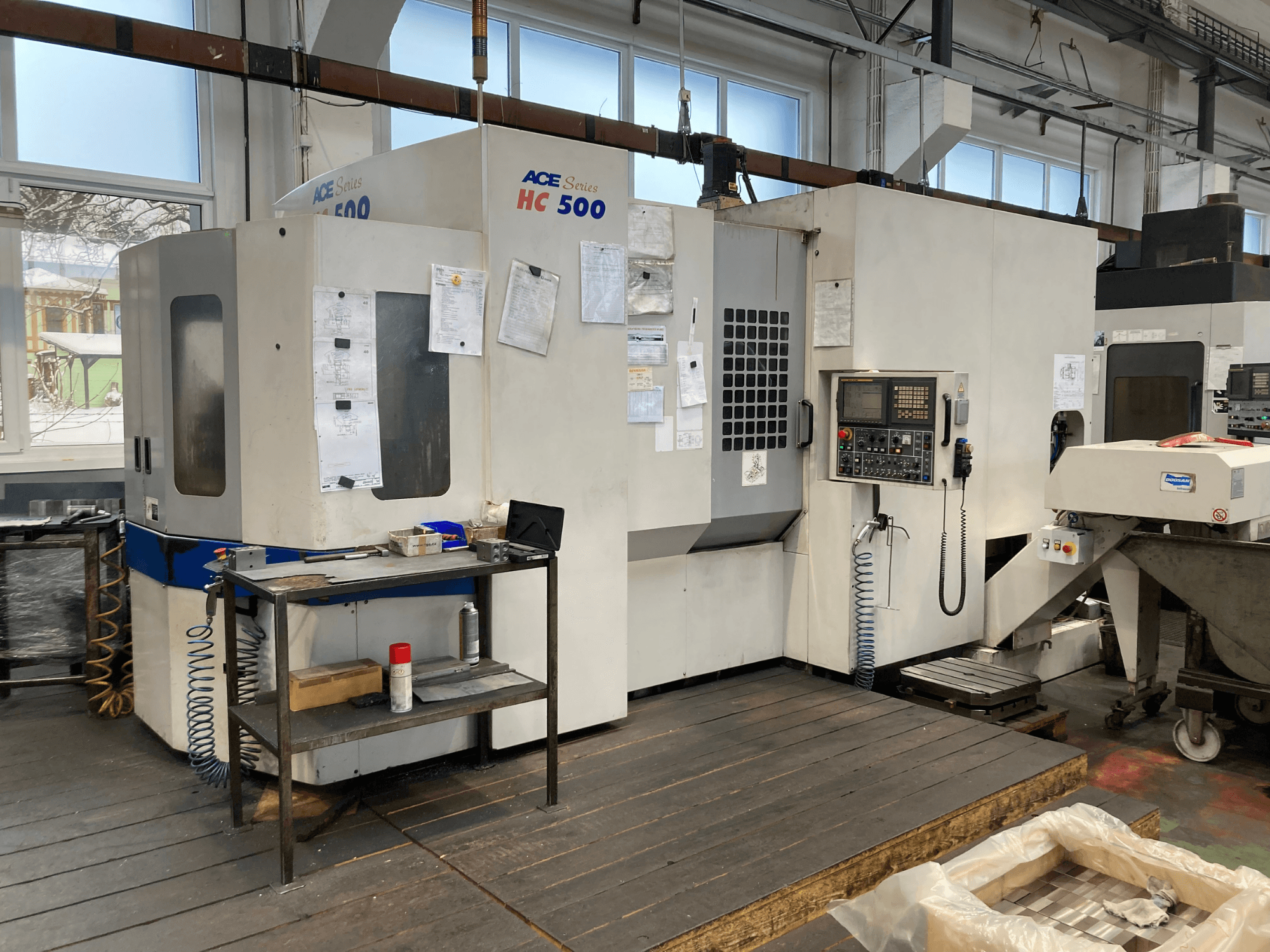 DOOSAN ACE HC-500 horizontal machining center, front view; features control panel, multiple tool storage, and industrial setting.