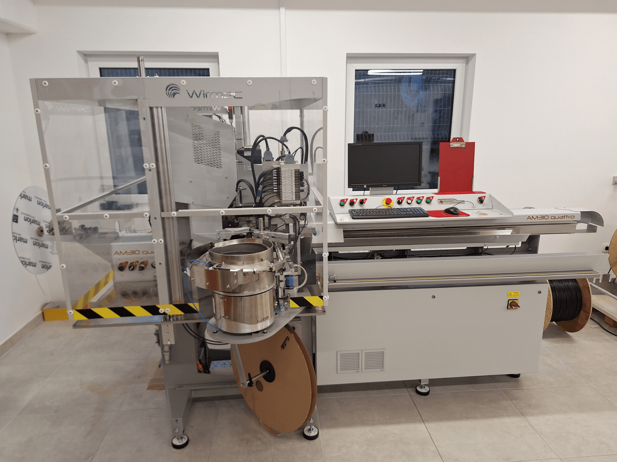 WIRMEC AM310-117 machine tool, front view, with control panel, computer, and stainless steel components, set in a workspace.