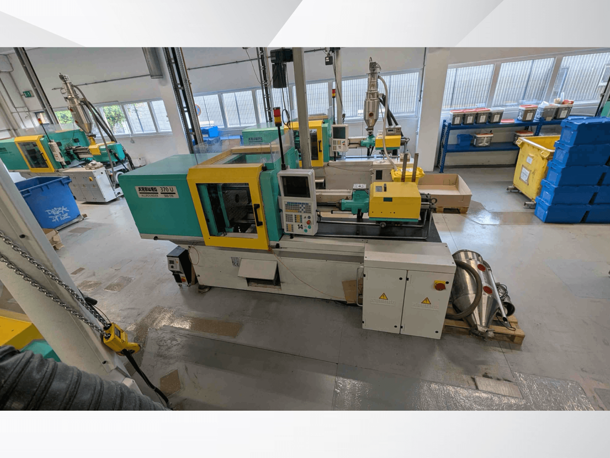 Front view of Arburg 370 U 500-170 vertical injection moulding machine with control panel and machinery components in a workshop.