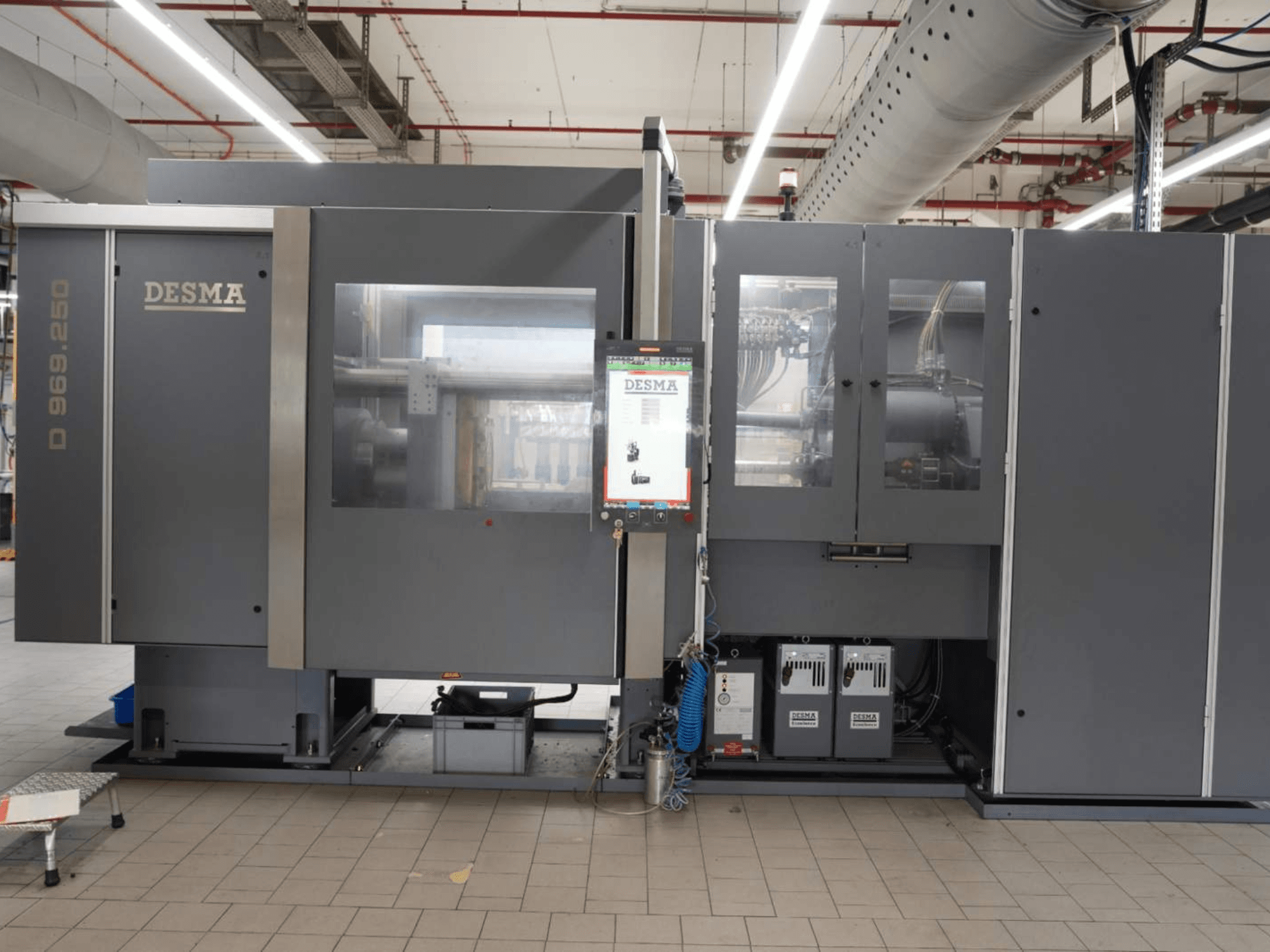 Vertical injection moulding machine Kloeckner Desma D 969.250 Z (S3) in a factory setting, front view with control panel.