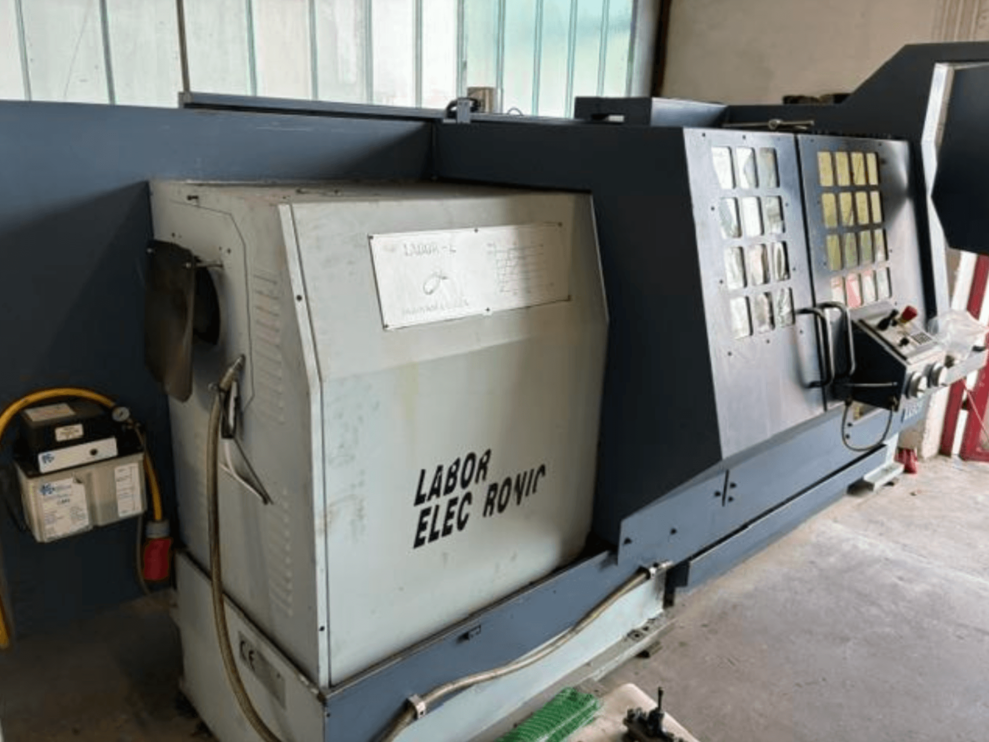 Horizontal turning machine PADOVANI E255/1500, side view showing controls, electrical panel, and operational features.