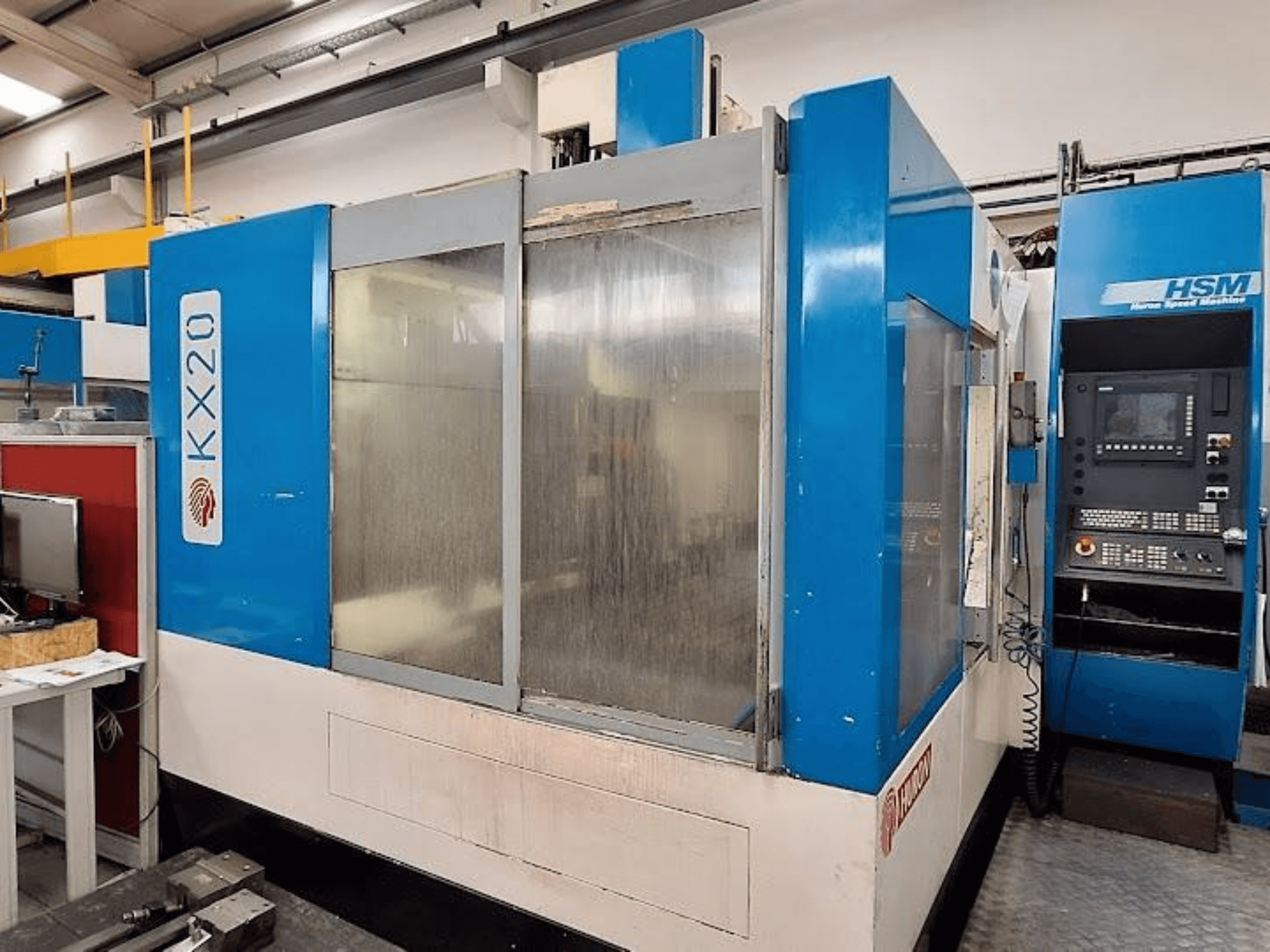 Huron KX20 Vertical Machining Centre, side view showing control panel and glass panels for visibility.