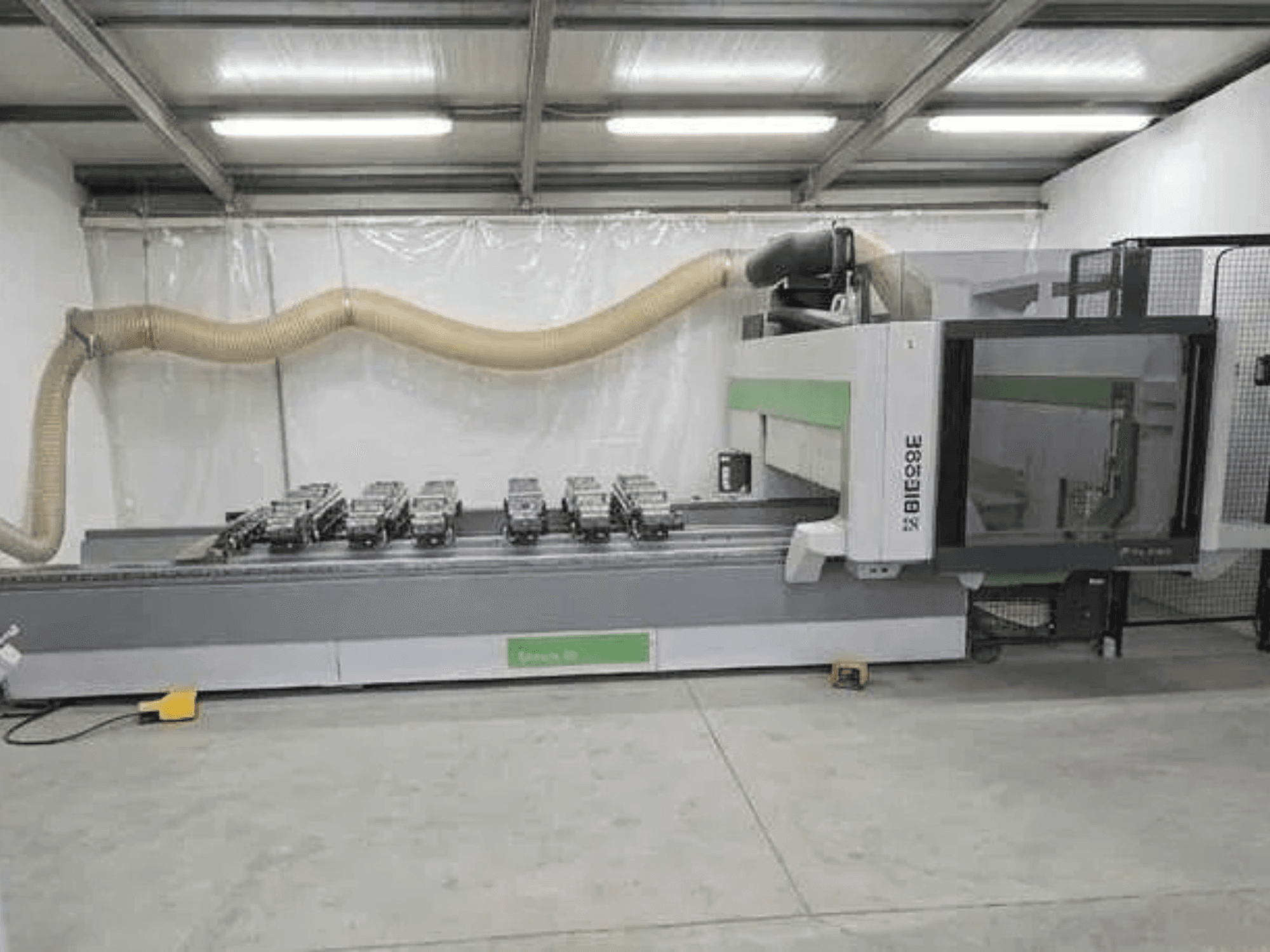 BIESSE Rover K1232 CNC processing center in side view with vacuum suction cups and dust extraction system visible.
