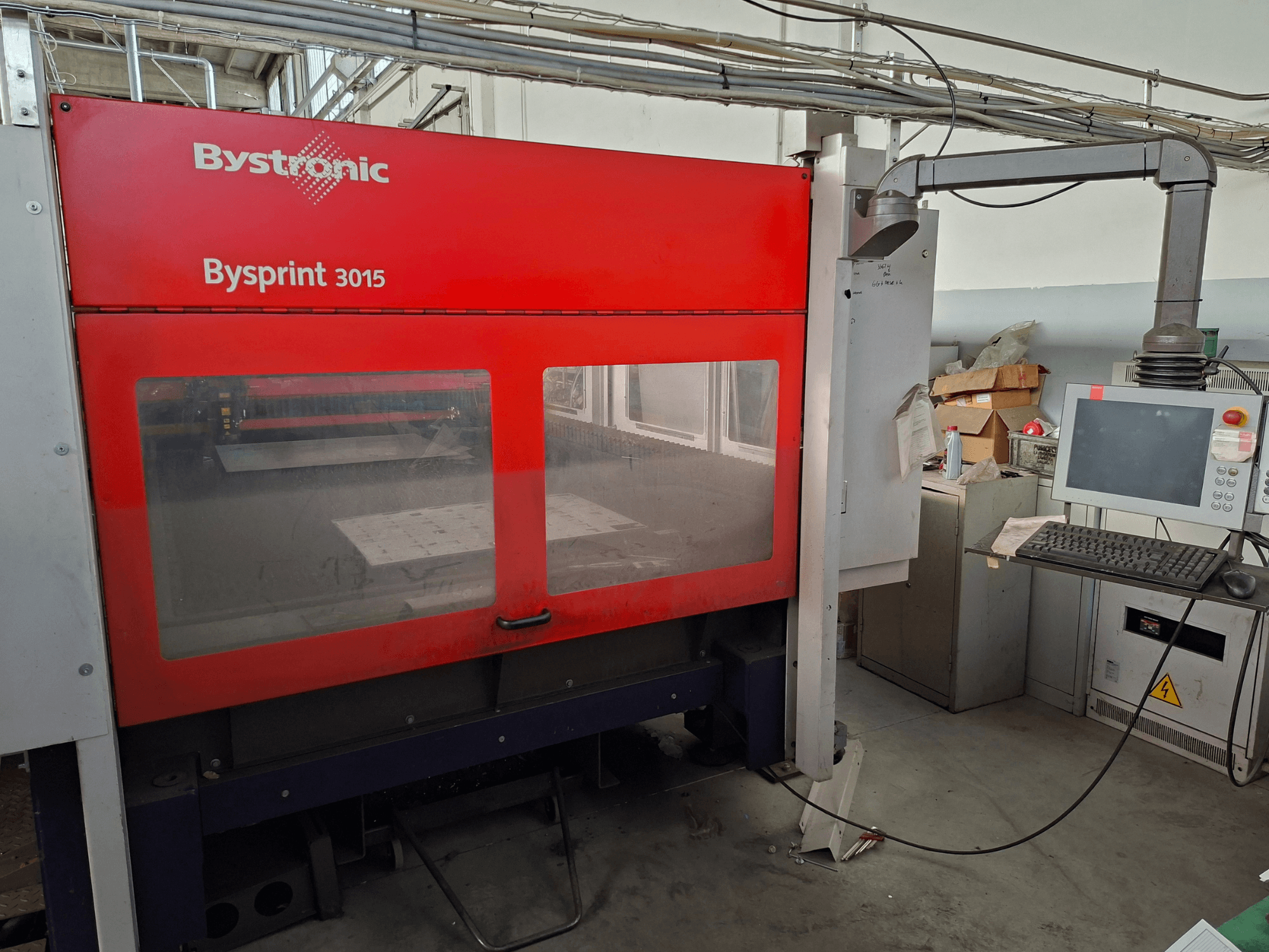 Bystronic Bysprint 3015 CO2 laser cutting machine, front view showing control panel and laser cutting area.