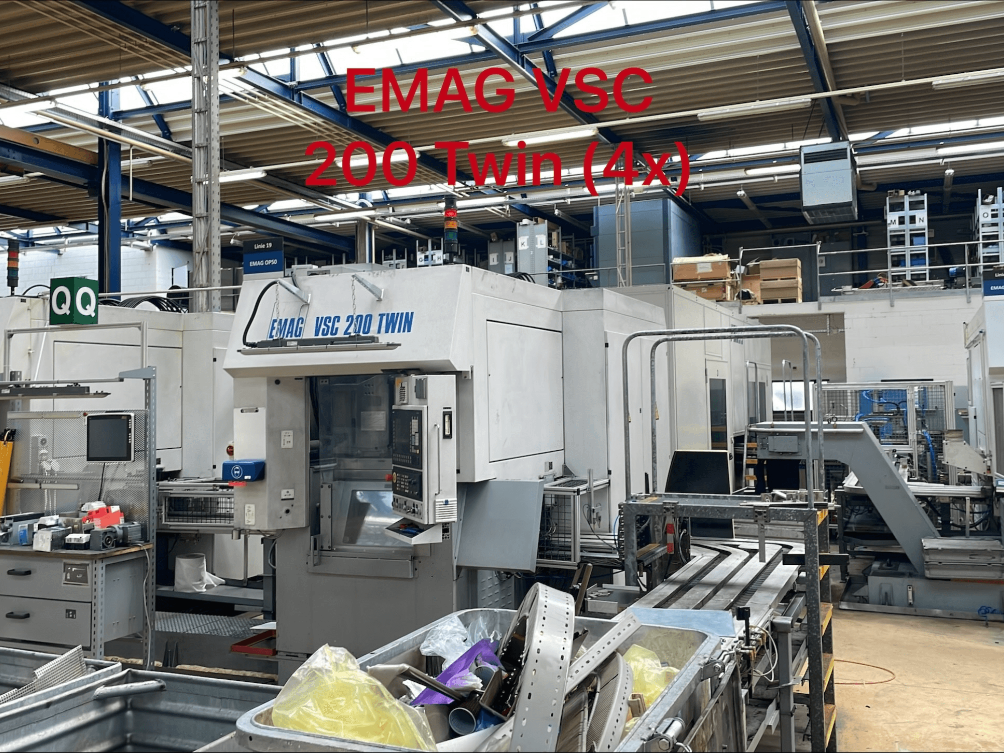 EMAG VSC 200 TWIN vertical turning machine in a factory setting, front view showcasing controls and tool storage area.