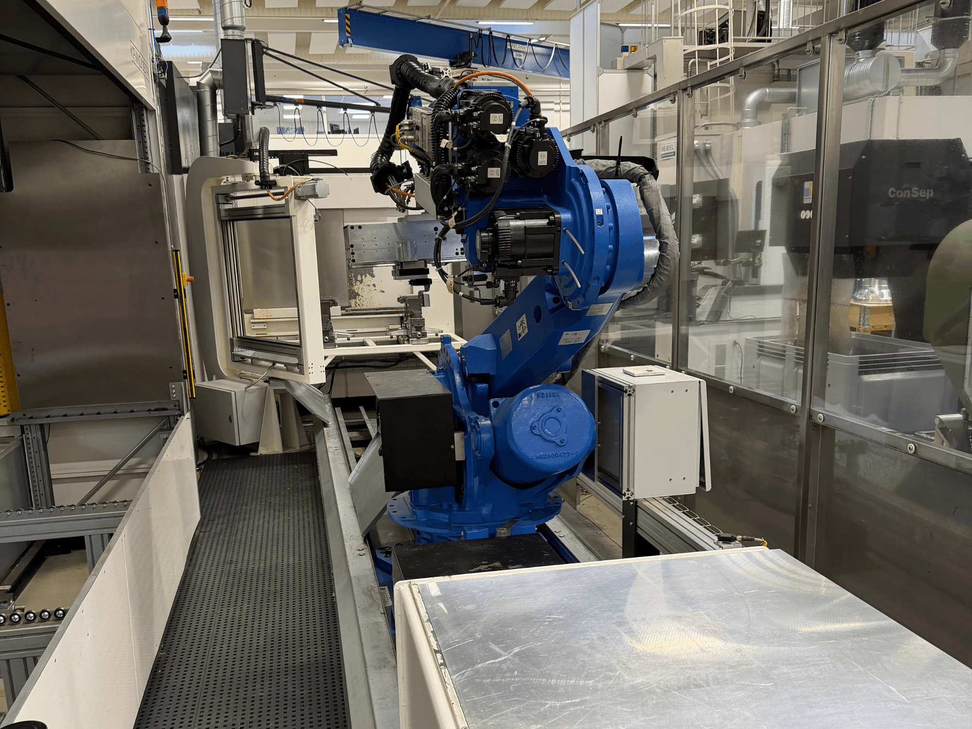 Yaskawa Motoman ES165D robotic arm on rail, side view showing automation setup in industrial environment.