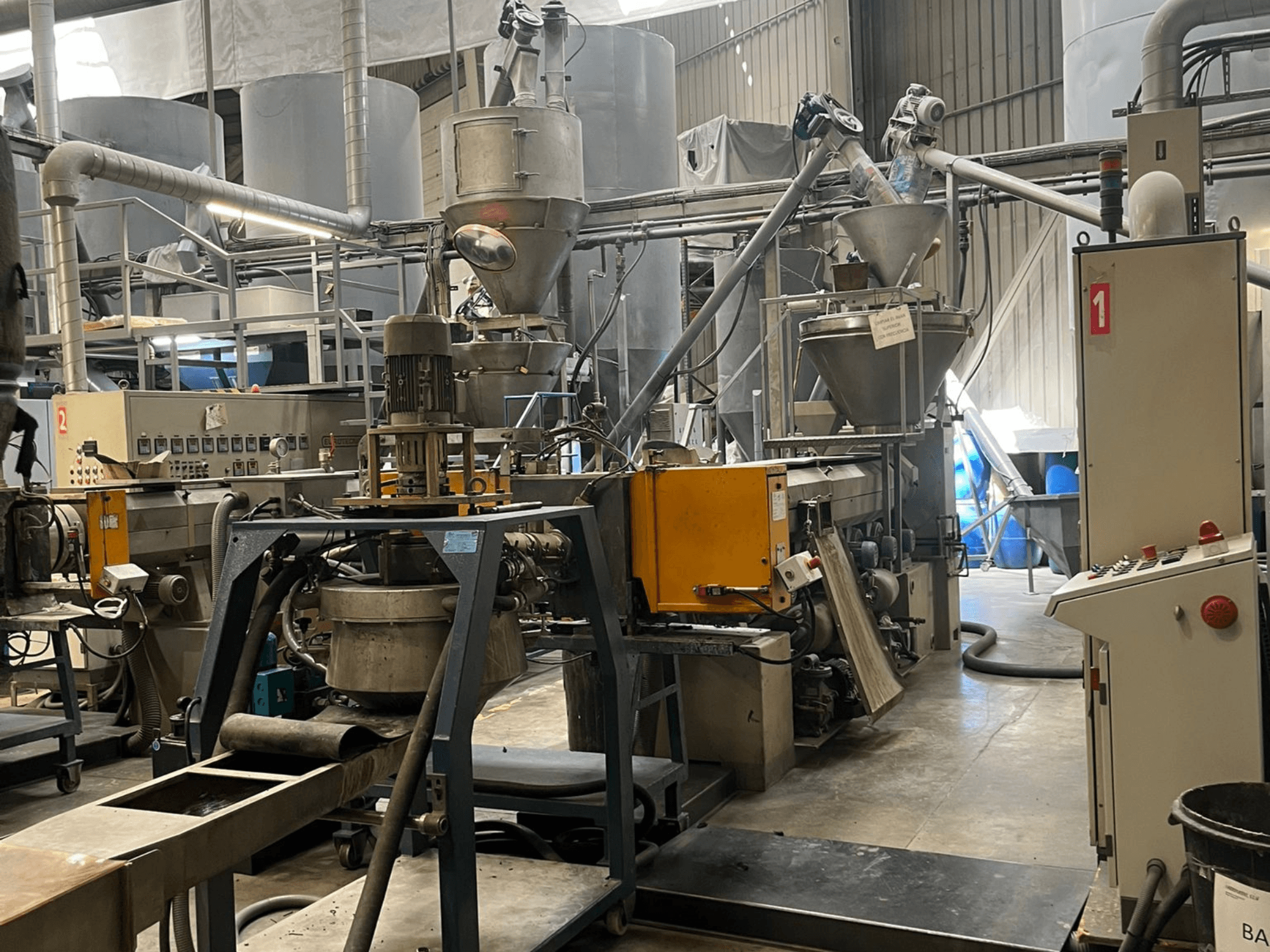 Single Screw Extruder EUROTECNO E12535D in a factory setting, featuring processing components, hoppers, and control panel.