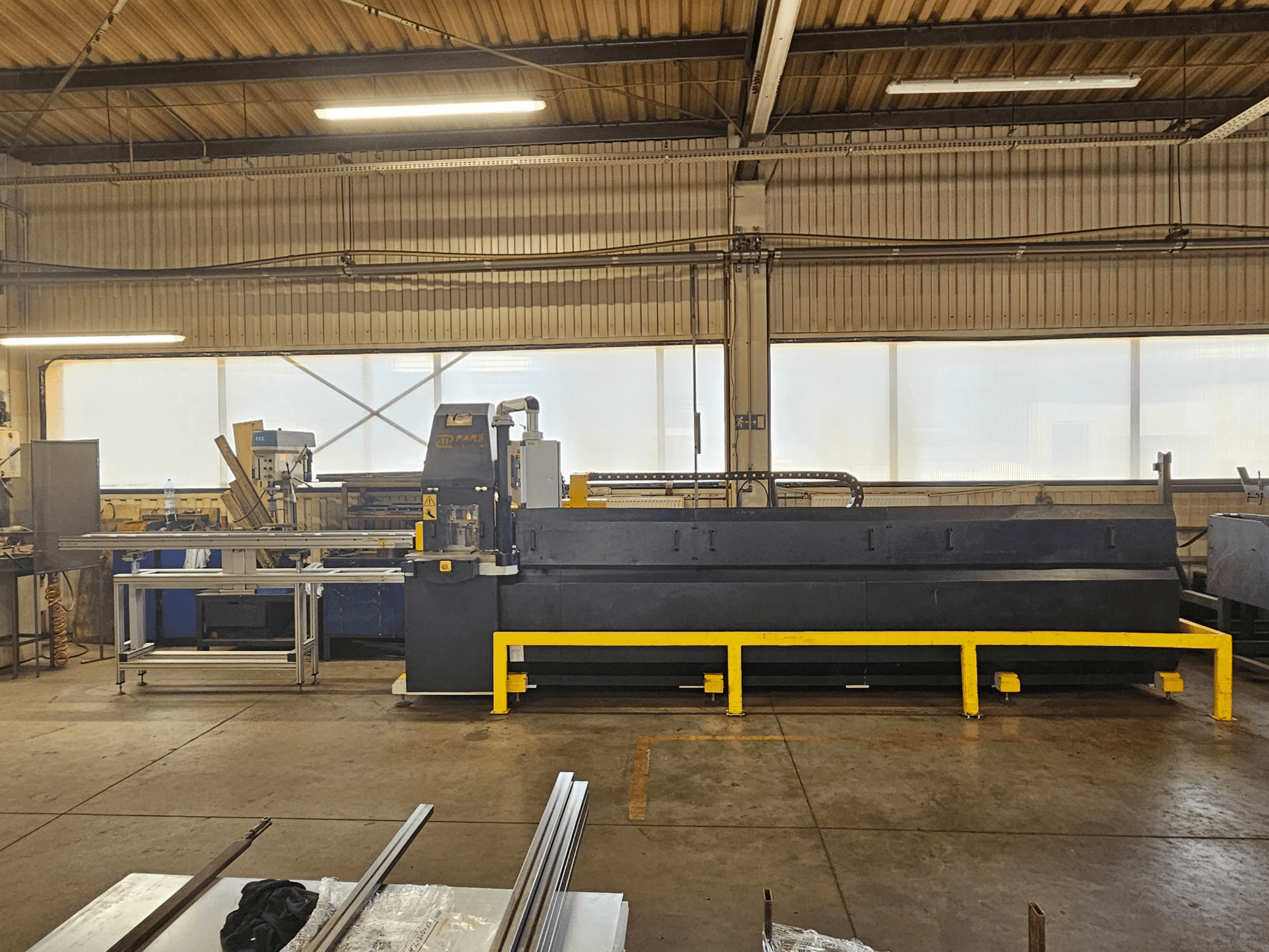 CNC punching machine PARS HMP SIRIUS PLUS-3000/3-L1, front view in industrial setting with metal surface and tools.