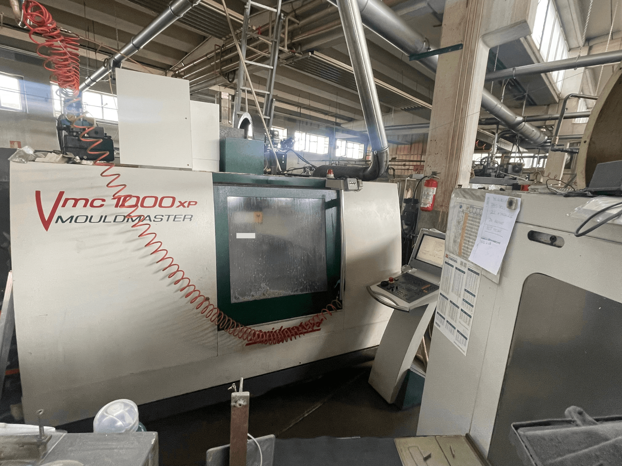 Vertical Machining Centre Bridgeport VMC 1000, front view, showing control panel and machine details in an industrial setting.