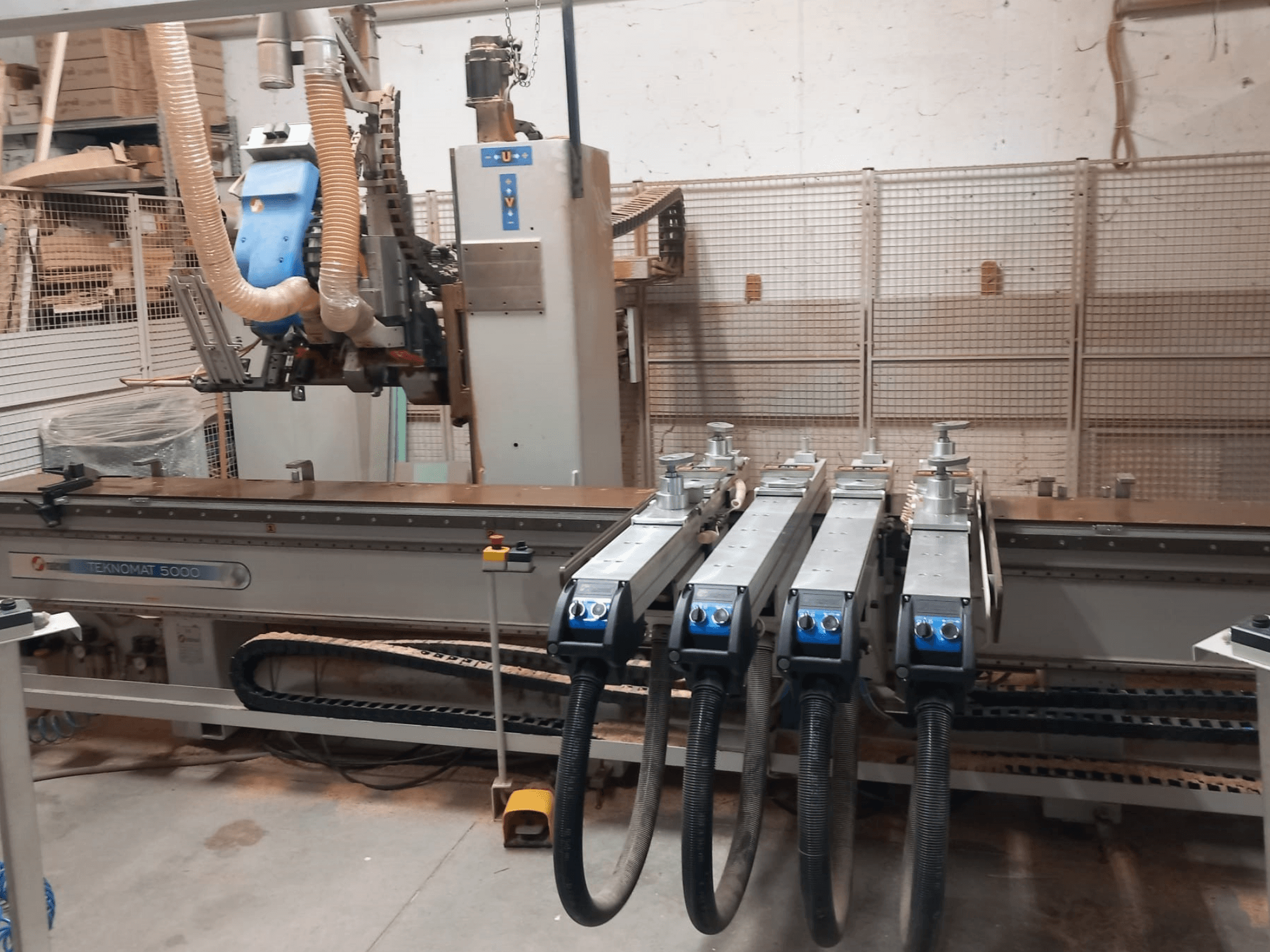 CNC Wood Machining Centre MASTERWOOD TEKNOMAT 5000, front view showcasing the tool head and multiple suction hoses.