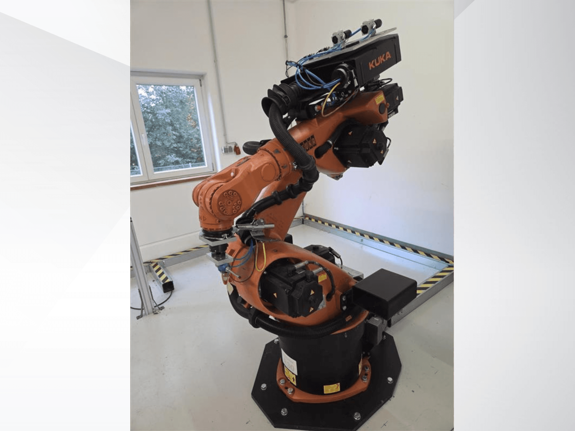 KUKA KR60 HA robot arm in side view, showcasing mechanical joints and wiring on an industrial base.