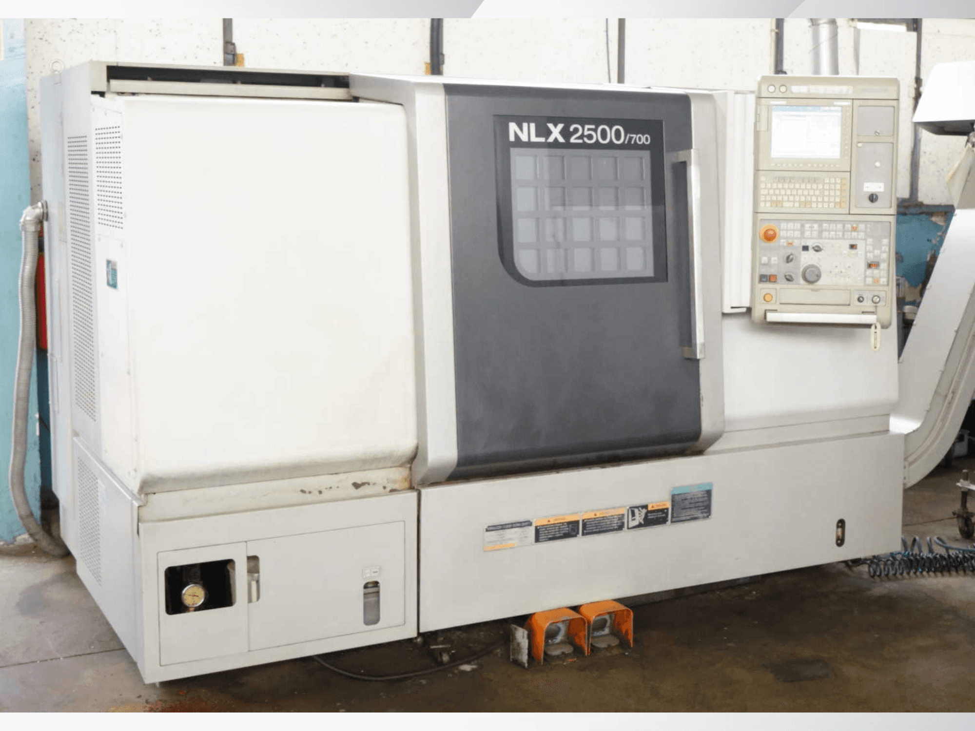 DMG MORI NLX 2500/700 horizontal turning machine, front view showing control panel and machine features.