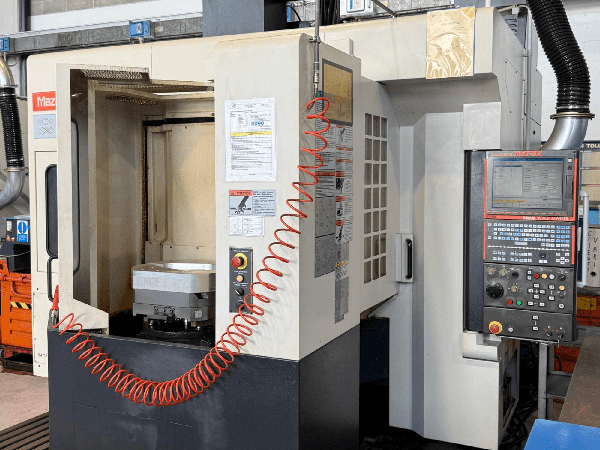 Mazak VARIAXIS I 500 vertical machining center in front view, showcasing control panel, part holder, and tool storage area.
