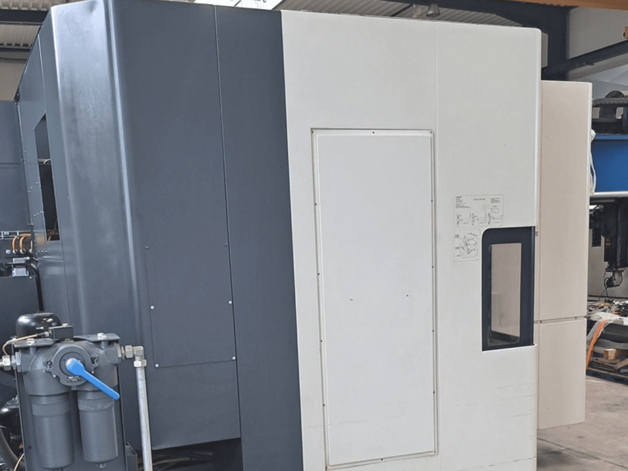DMG MORI NHX5000 horizontal machining centre, side view showing control panel and mechanical features.