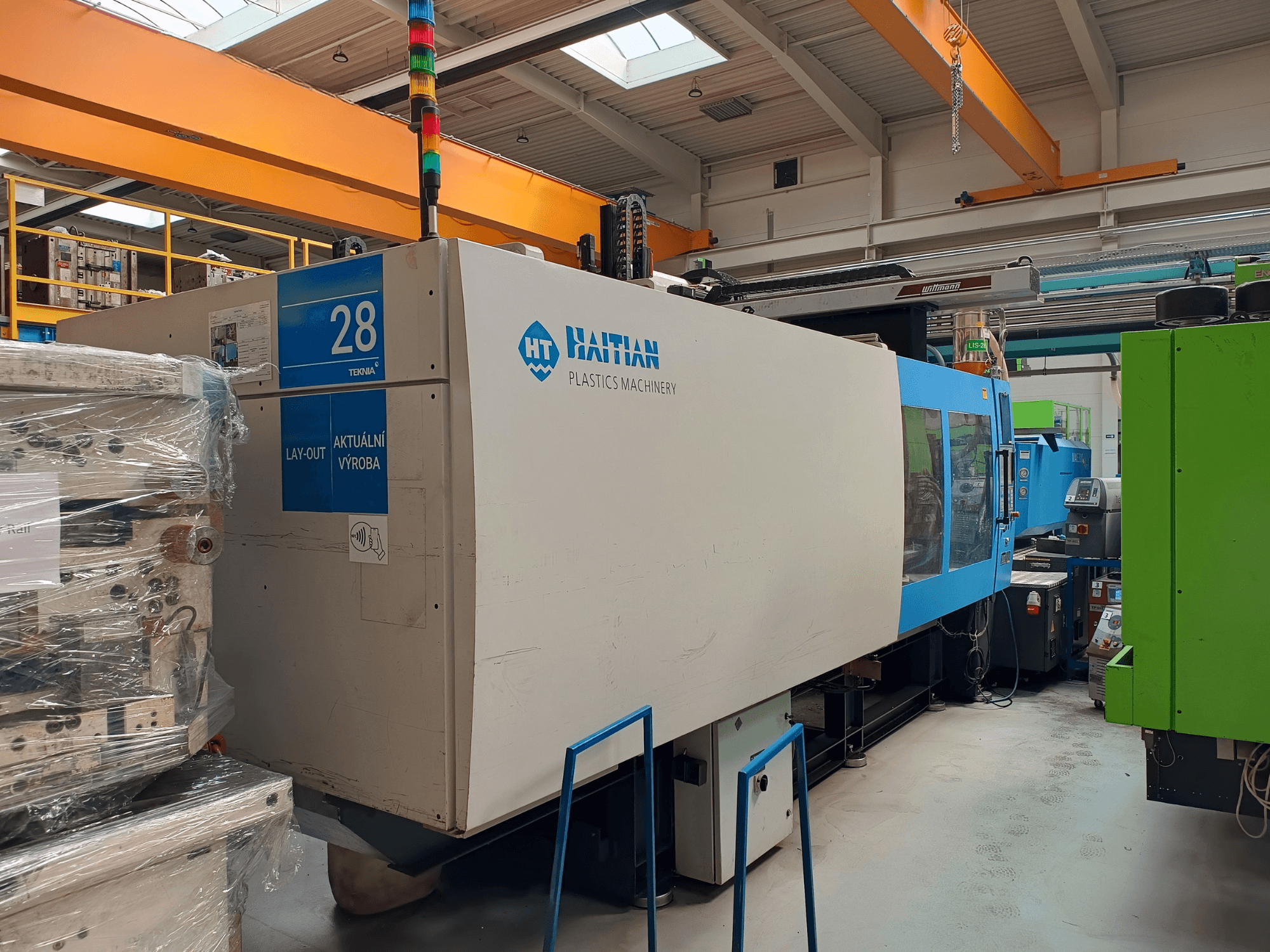 HAITIAN MARS 5300/4500 hydraulic injection molding machine, front view, showcasing control panel and blue/white casing.