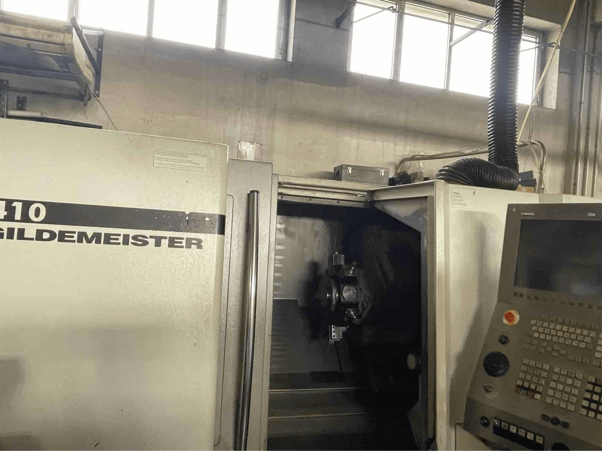 DMG CTX410 horizontal turning machine, front view, showing control panel and visible machining components inside.