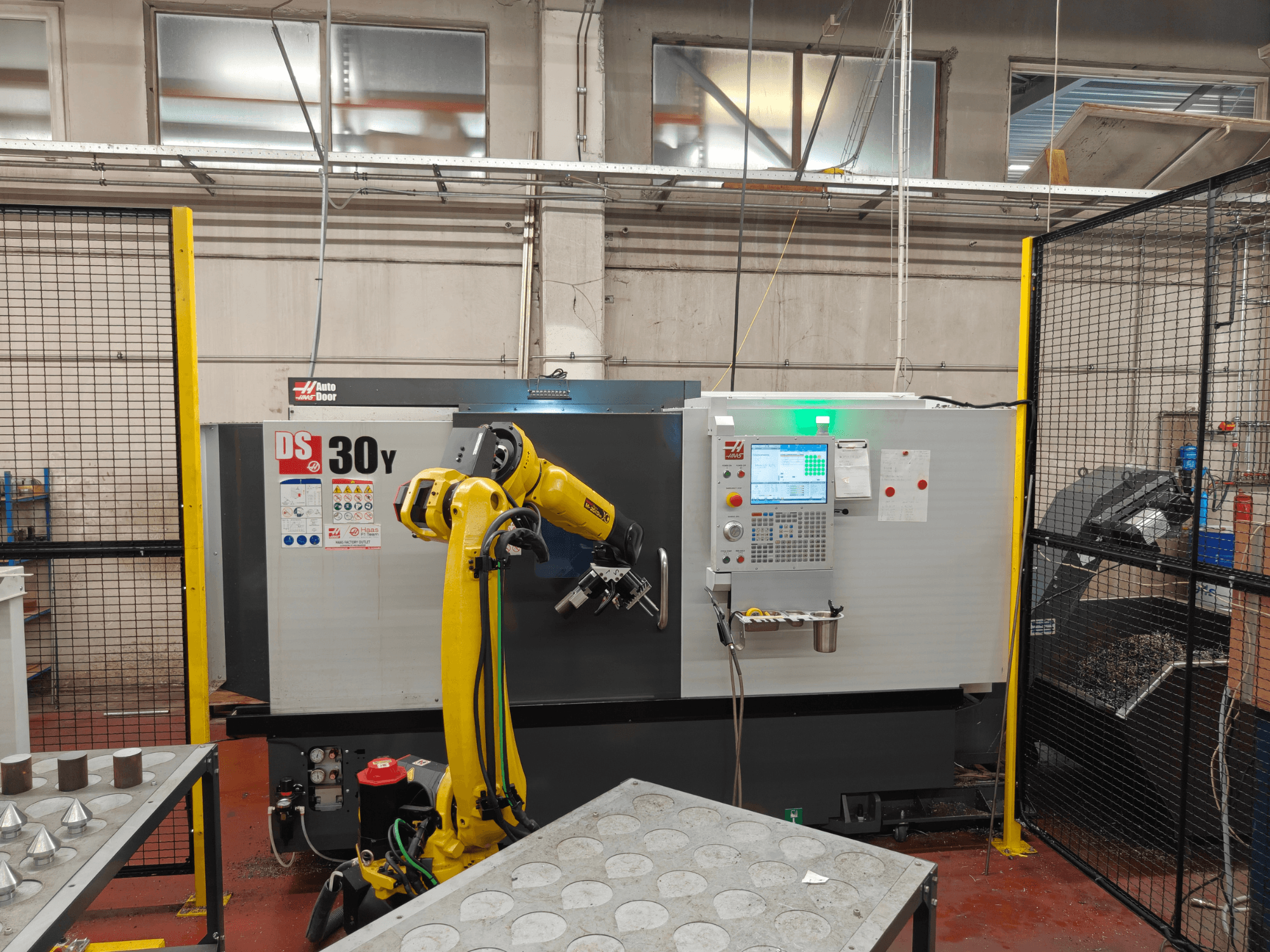 HAAS DS30Y horizontal turning machine with robotic arm, front view, showcasing control panel and workspace.