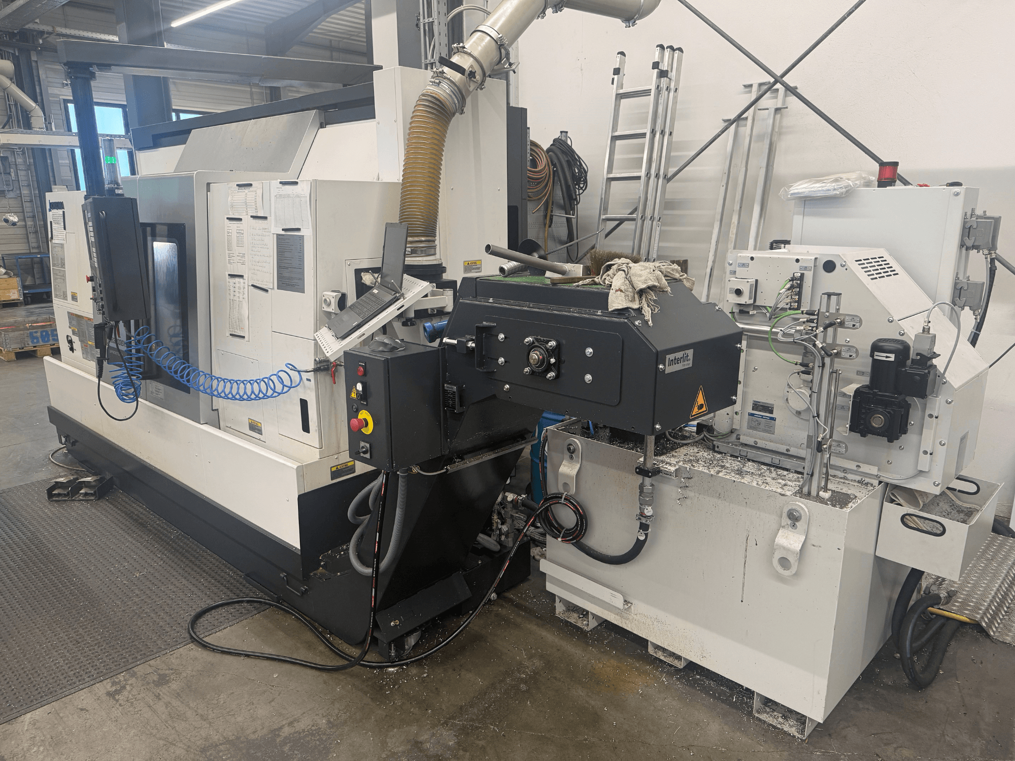 Okuma LB3000II-MYC 950 horizontal turning machine, front view, showcasing control panel and coolant system.
