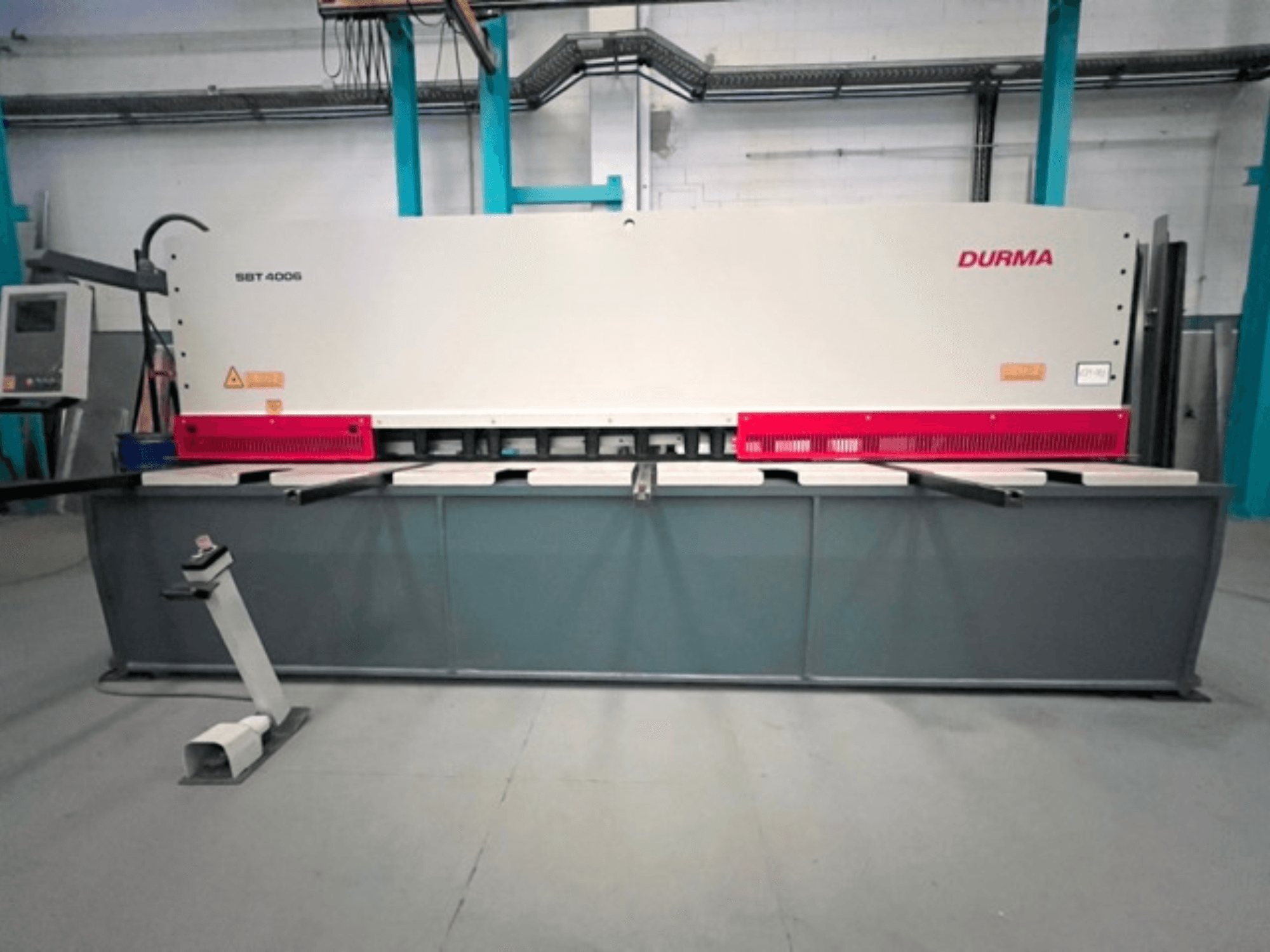 CNC Shearing Machine Durma SBT 4006 in front view, featuring a gray base and red accents, ready for operation in a factory setting.
