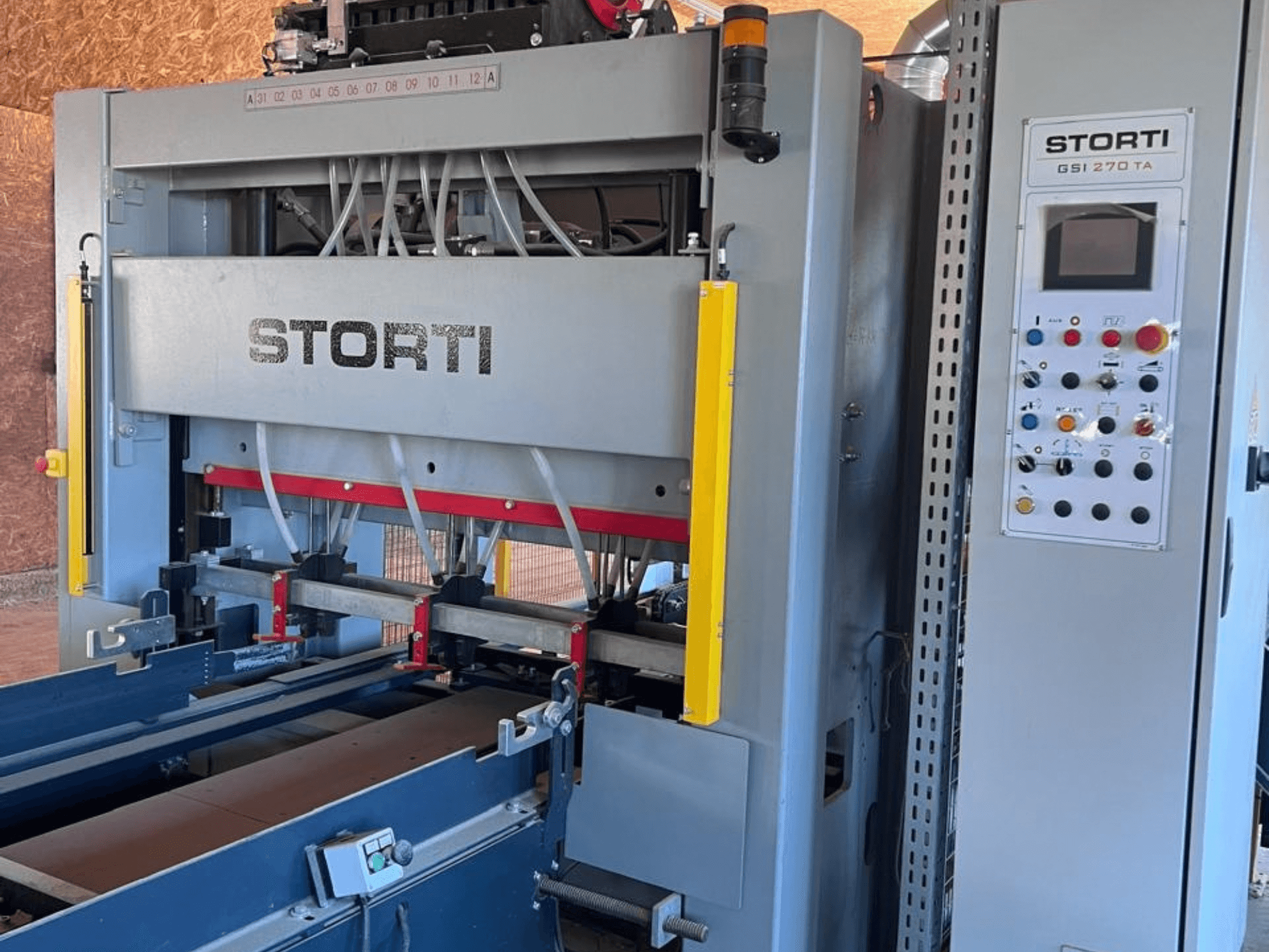 STORTI GSI 170-270 TA9 wood production line, front view showing control panel and hydraulic press mechanisms.