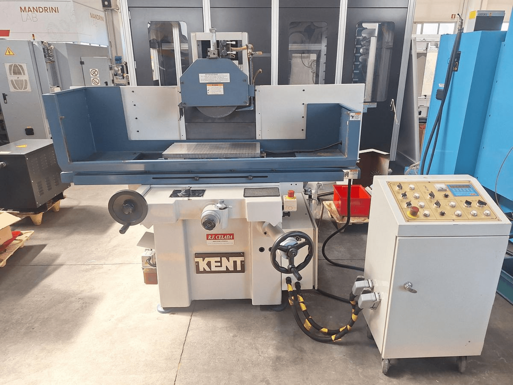 Kent KGS-63 SD surface grinding machine in front view, featuring control panel and work table with grinding wheel mounted.