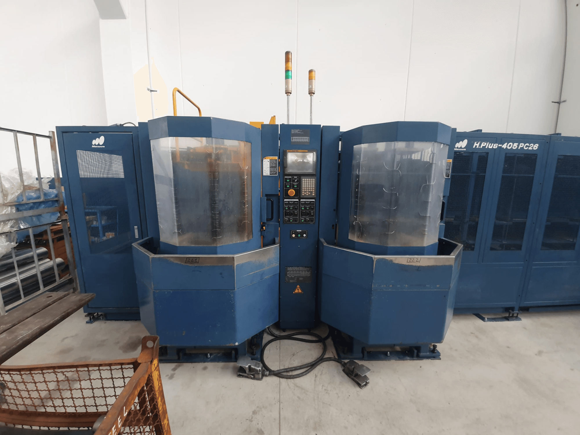 H.Plus 406 PC26 dual machine tool, front view, features control panel, transparent enclosure, and connected machinery base.