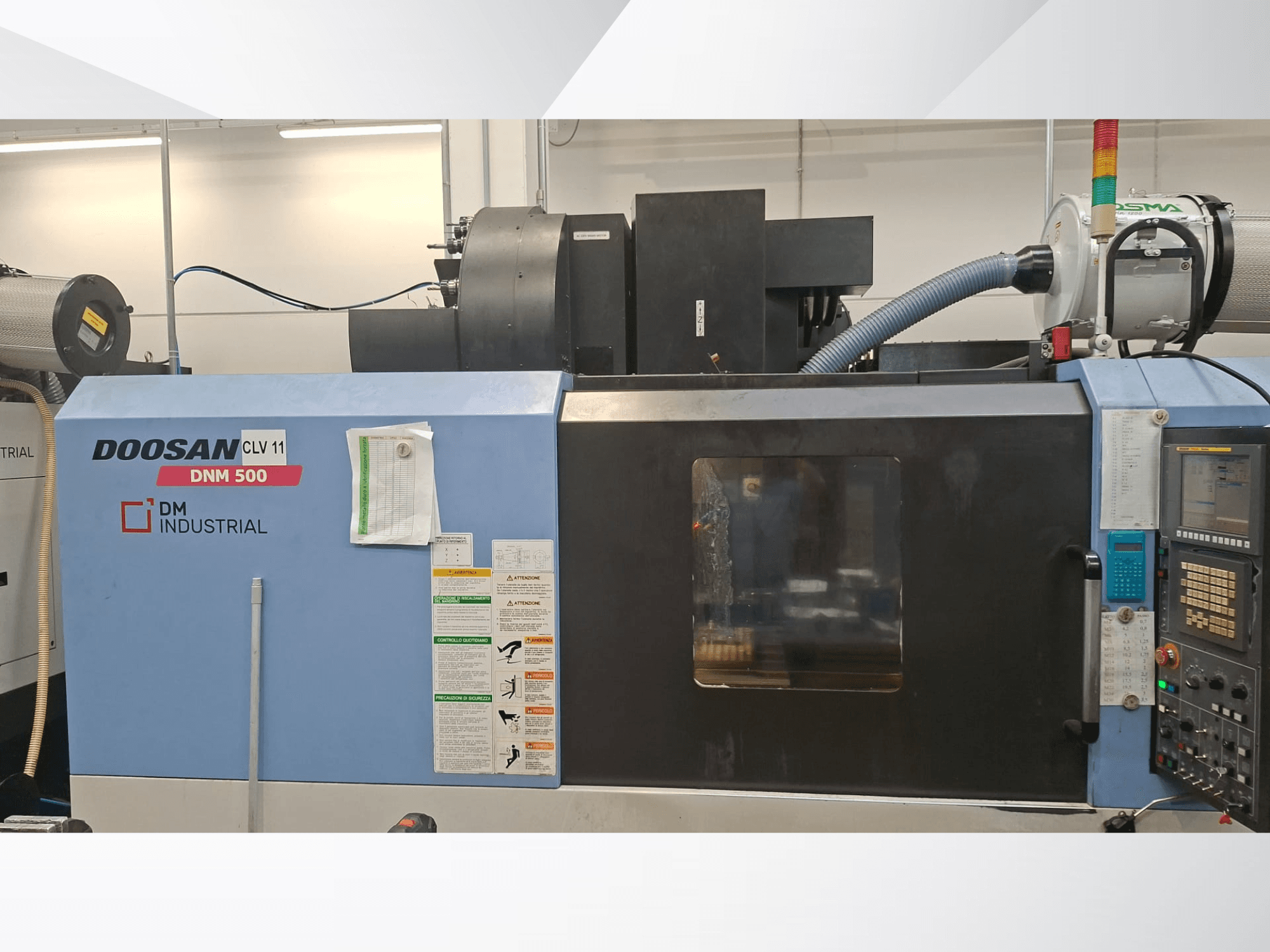 DOOSAN DNM 500 Vertical Machining Centre in side view, featuring control panel and operational parts.