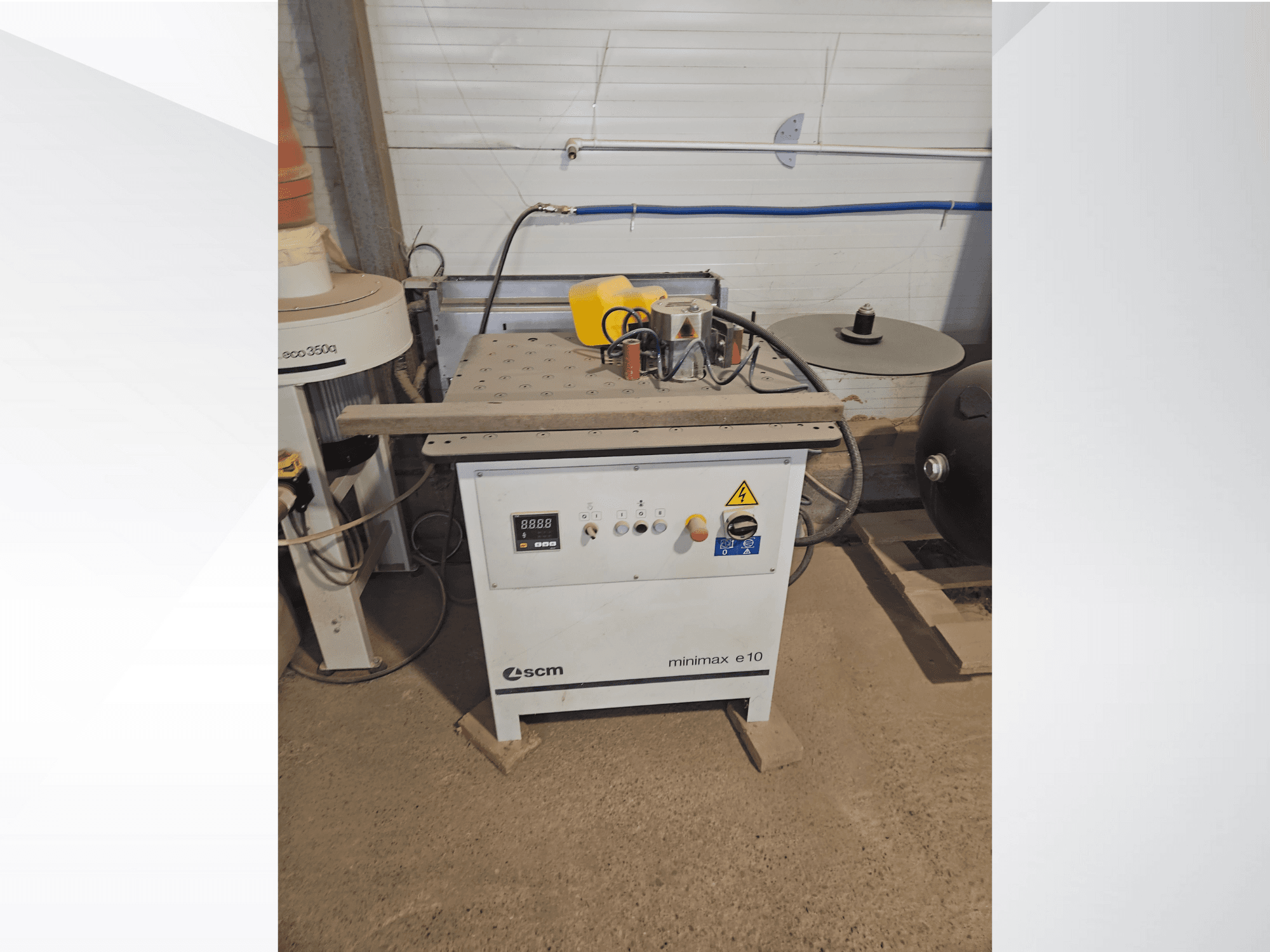 SCM Minimax E10 woodworking machine, front view, featuring control panel, dust port, and adjustable work surface.