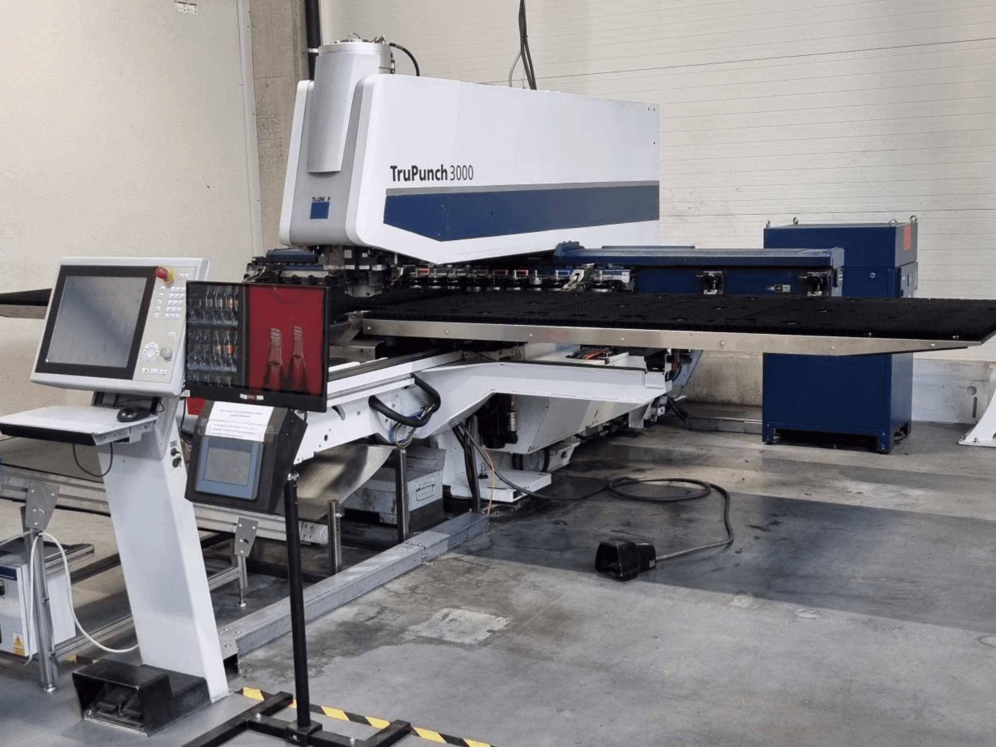 CNC punching machine TRUMPF TruPunch 3000 in front view, featuring control panel and large punch table.