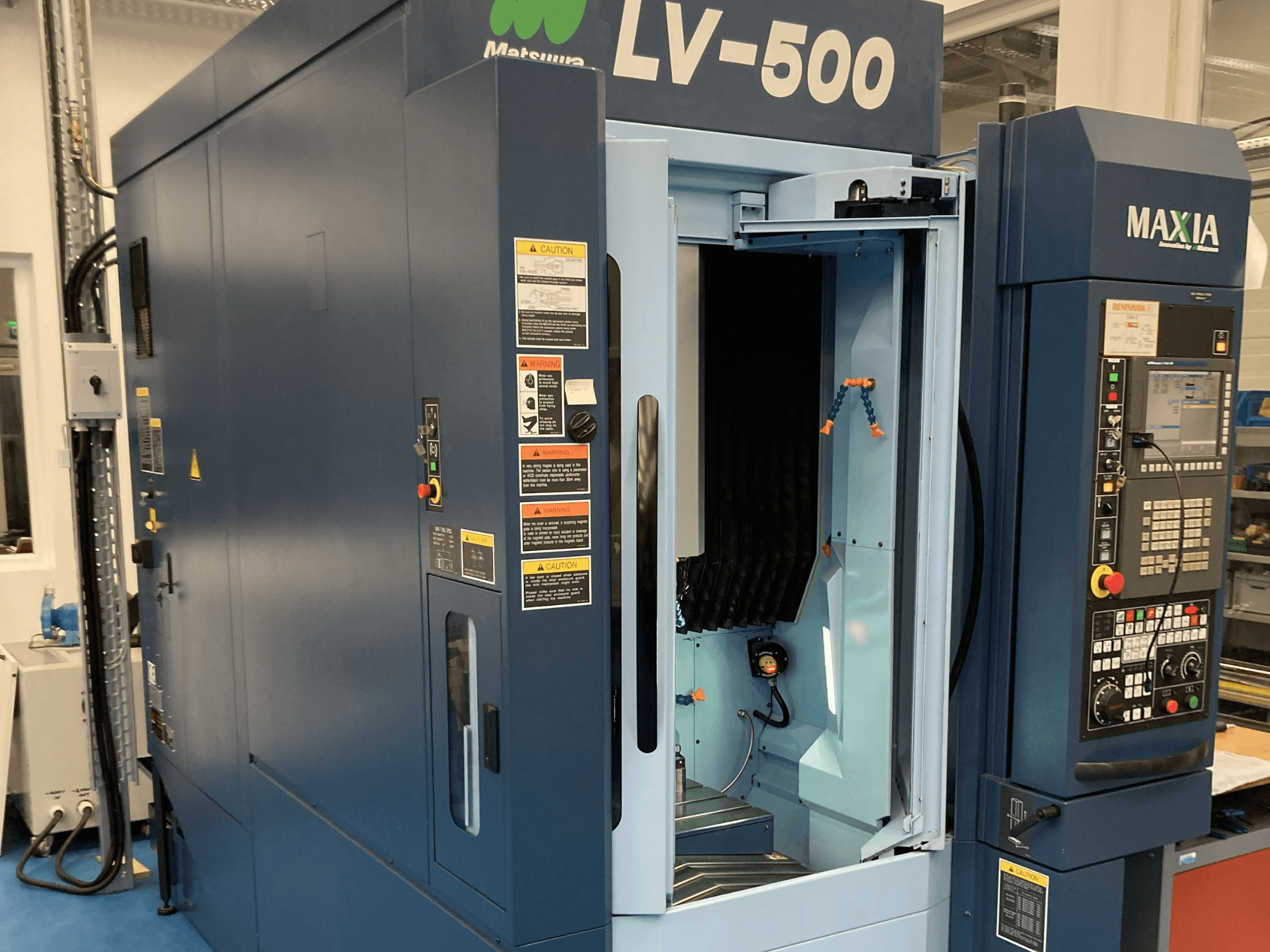 Matsuura LV-500 vertical machining center shown from a front view, featuring an open door and control panel with buttons.