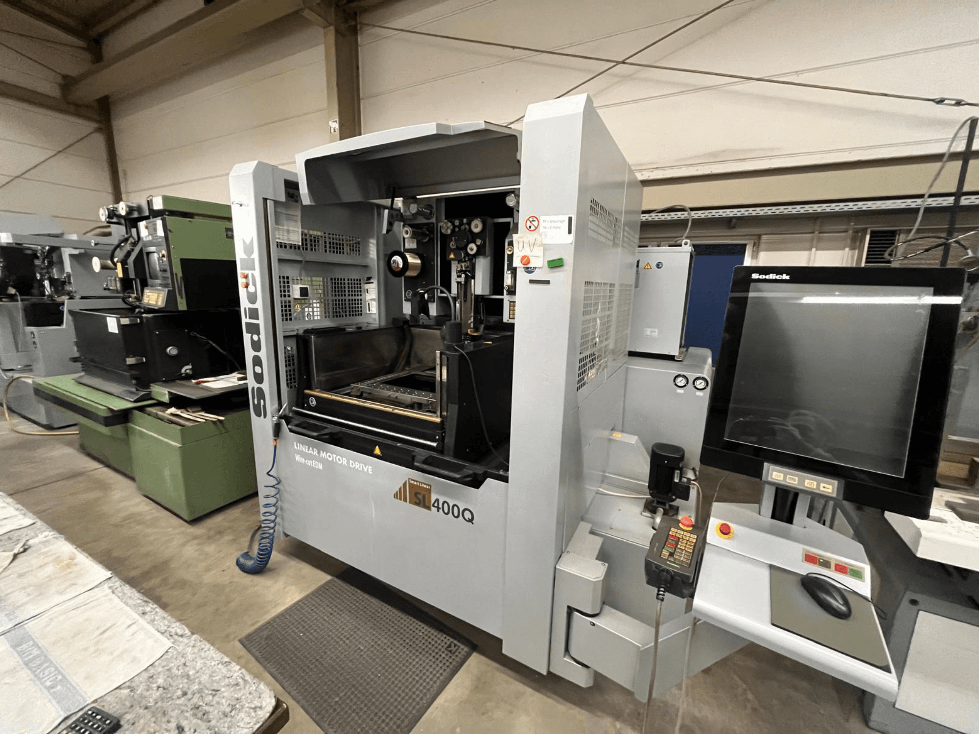 Sodick SL400Q linear motor drive CNC machine, front view with digital control panel and display in a workshop setting.