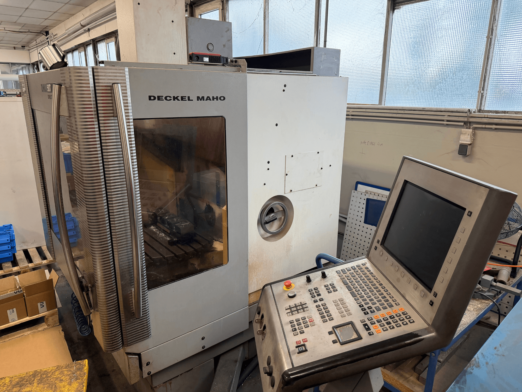 DECKEL MAHO DMU 50T universal machining center in side view, featuring a control panel and visible spindle area.