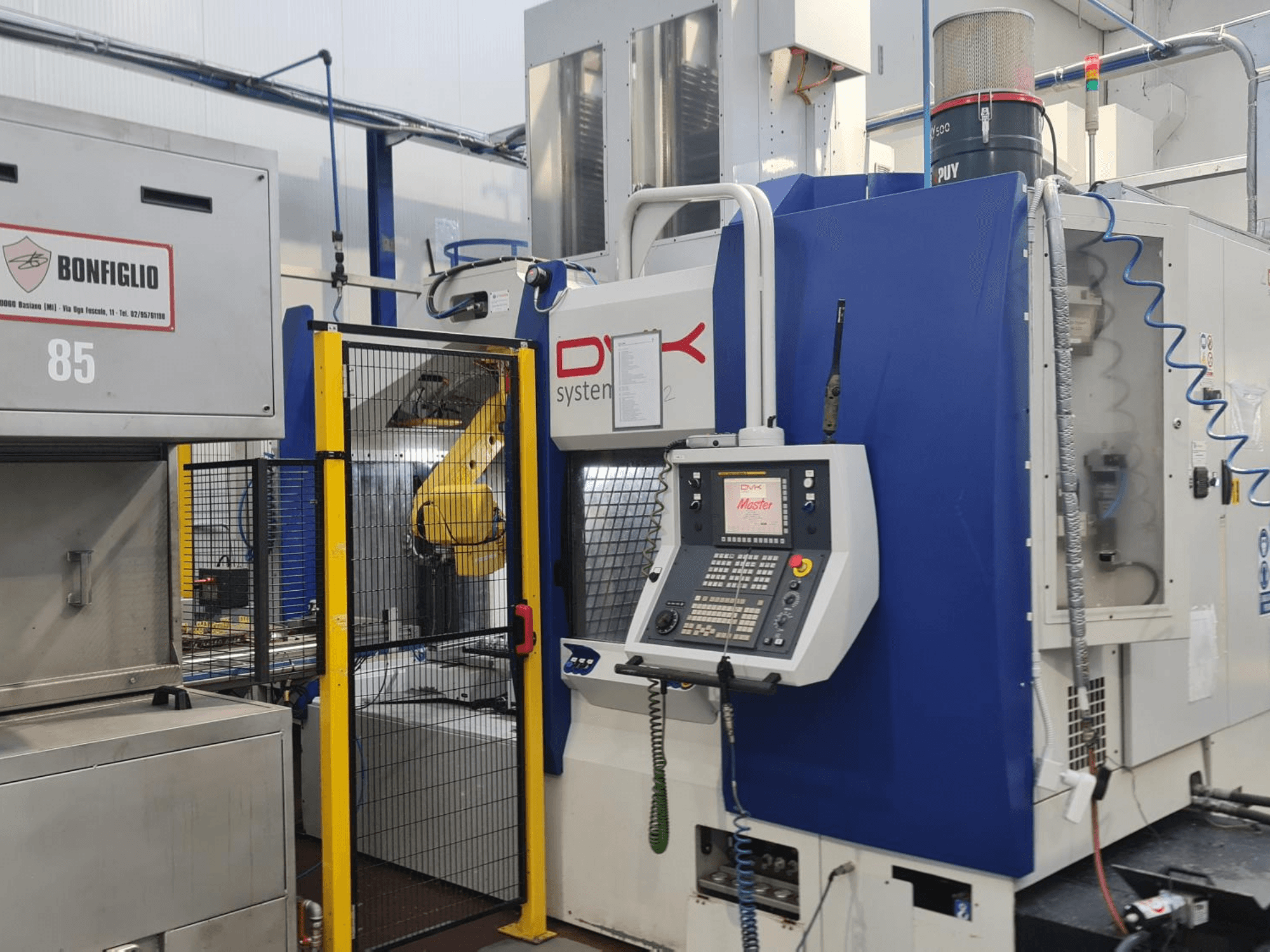 DVK System Master horizontal machining center, front view, featuring control panel, safety gate, and robotic arm.
