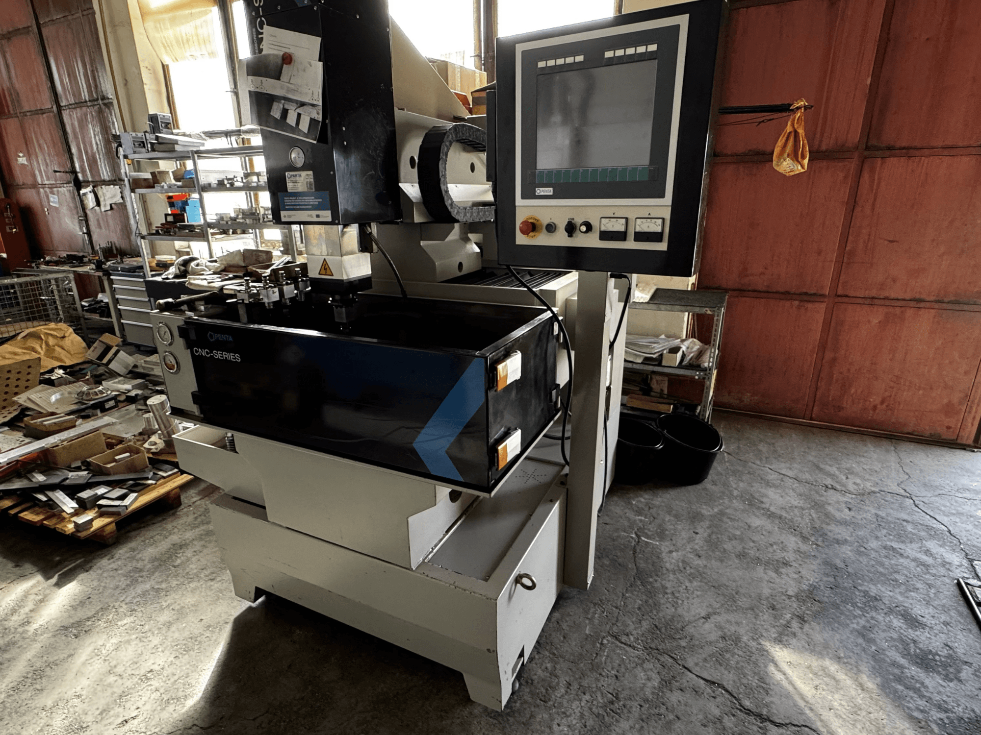 PENTA 433GS CNC die-sinking EDM machine, front view. Displays control panel, electrode holder, and metallic work table.