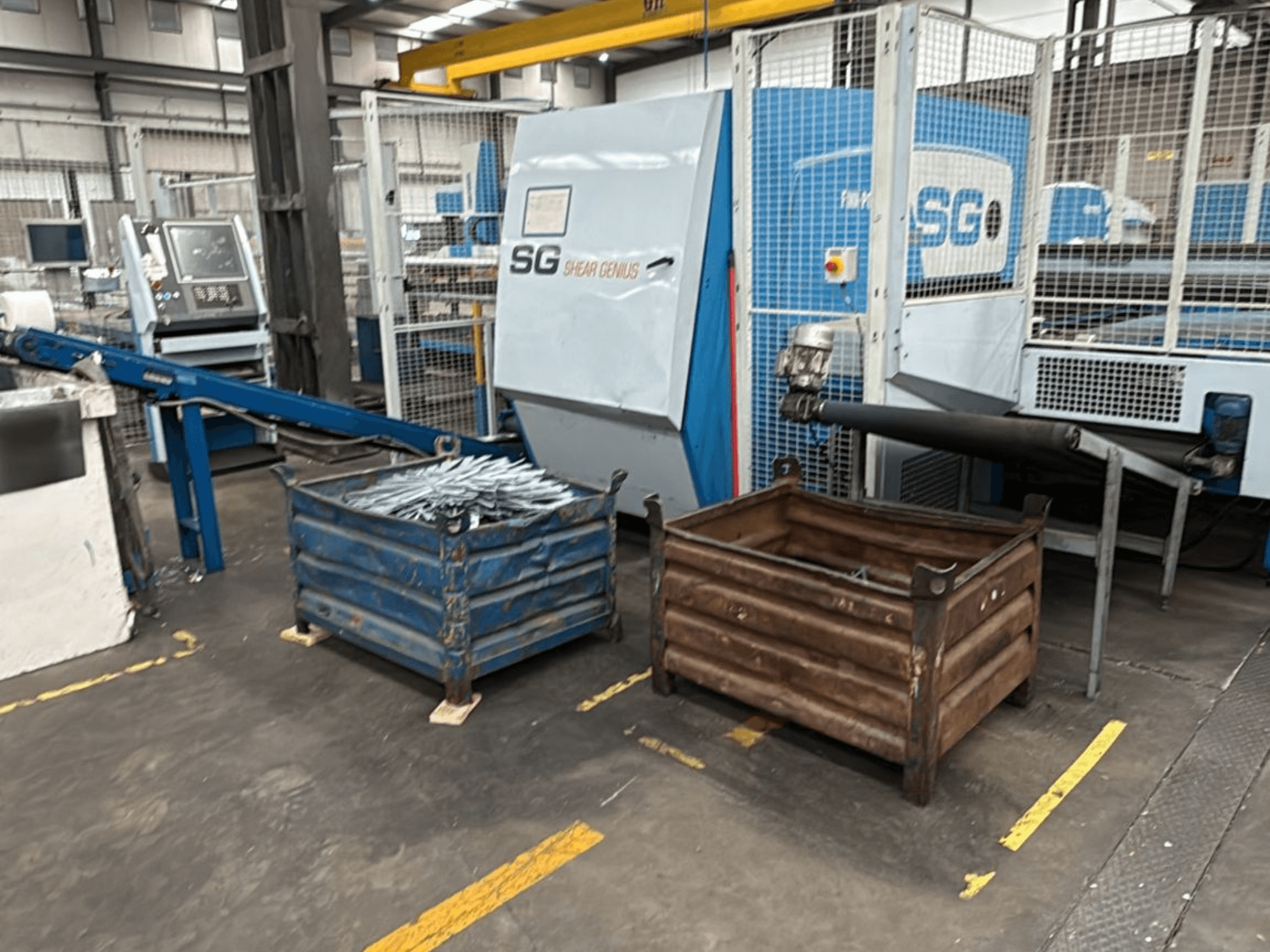 Finn-Power SG6 12.61 punching and bending machine, front view with metal containers beside it in a workshop setting.