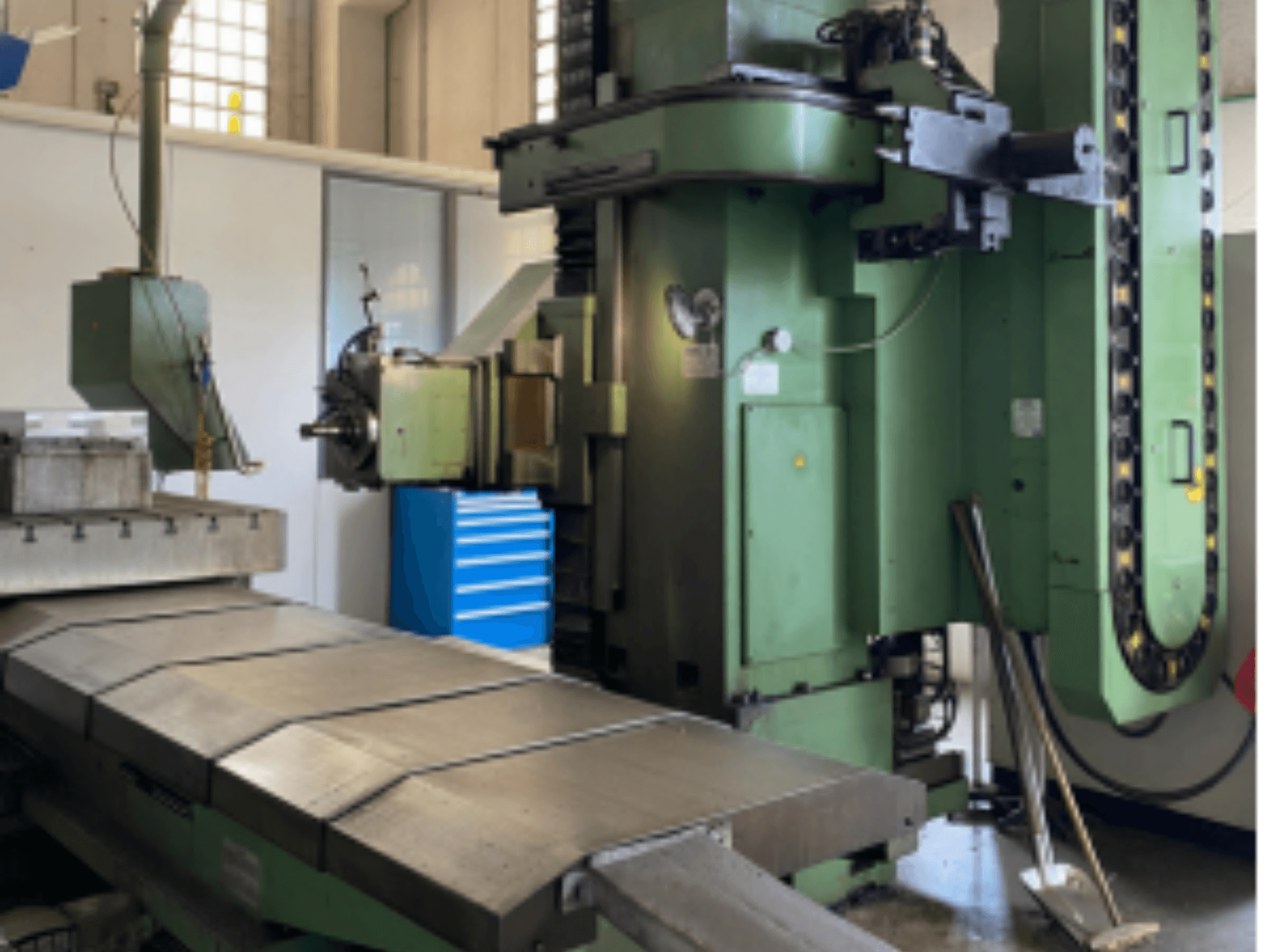 Front view of DEBER BTM 5A bed type milling machine, showcasing a large metal table and control panel with a green finish.