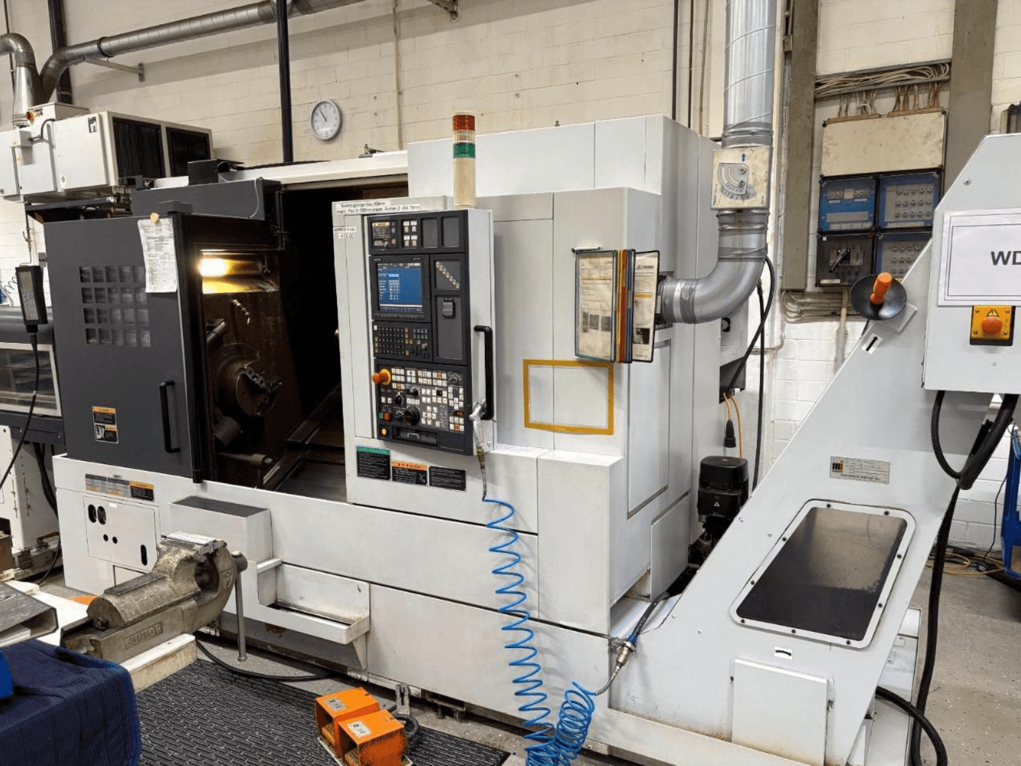 MORI SEIKI NL 2500 SY Turn-Mill Centre, front view, showing control panel and machining area. Visible coolant system and accessories.