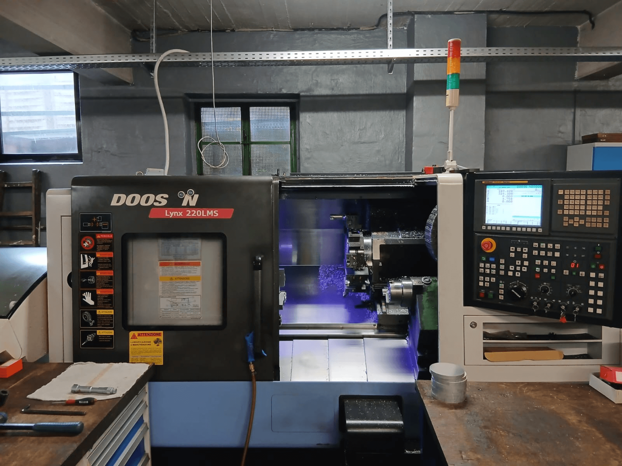 DOOSAN Lynx 220 LMS horizontal turning machine, front view, featuring control panel and visible machining area.