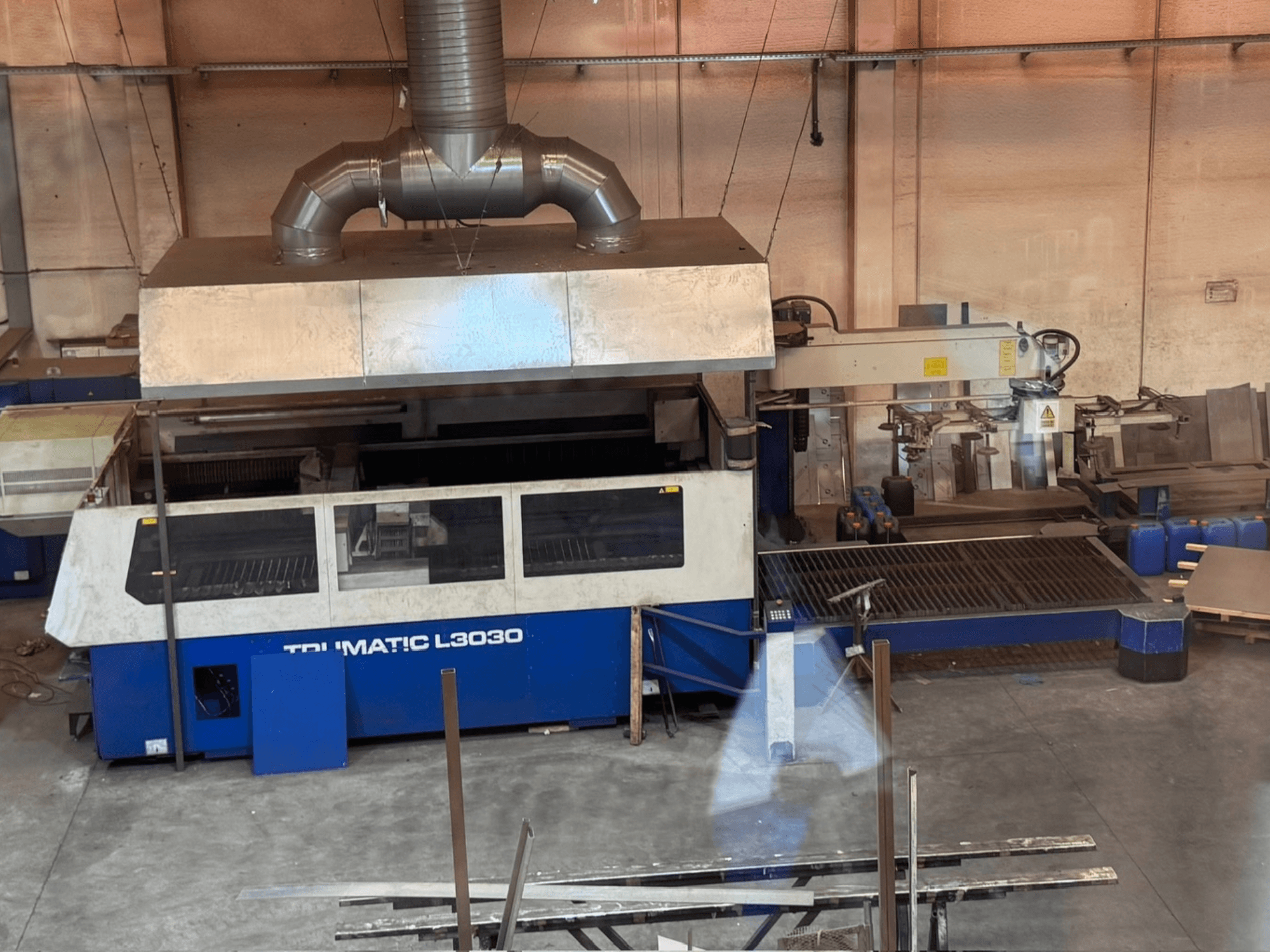 CO2 Laser Cutting Machine TRUMPF TRUMATIC L3030 in a workshop, front view showing control panel and cutting bed.