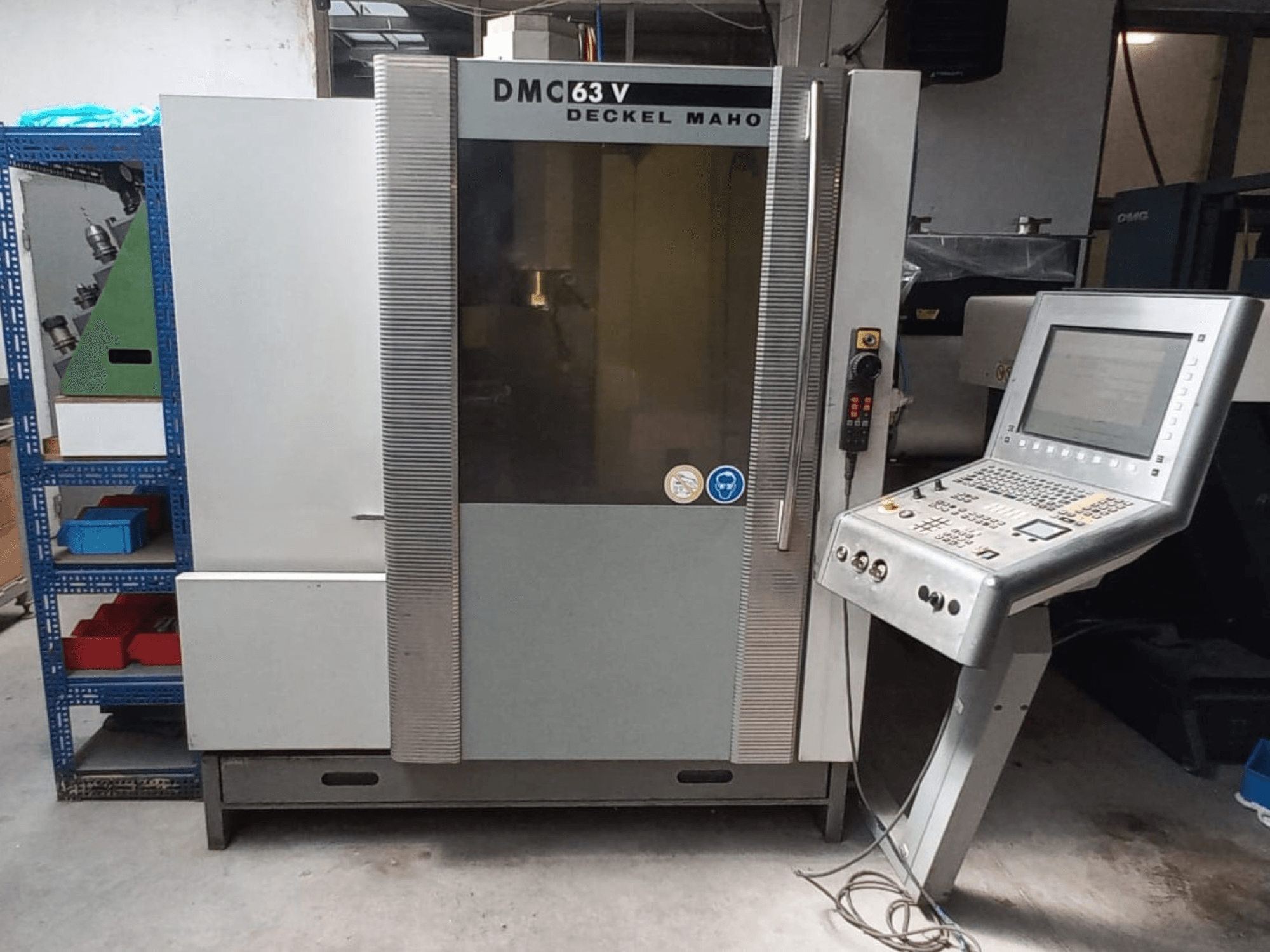 Front view of DMG DECKEL MAHO DMC 63V vertical machining center with control panel and visible workspace.