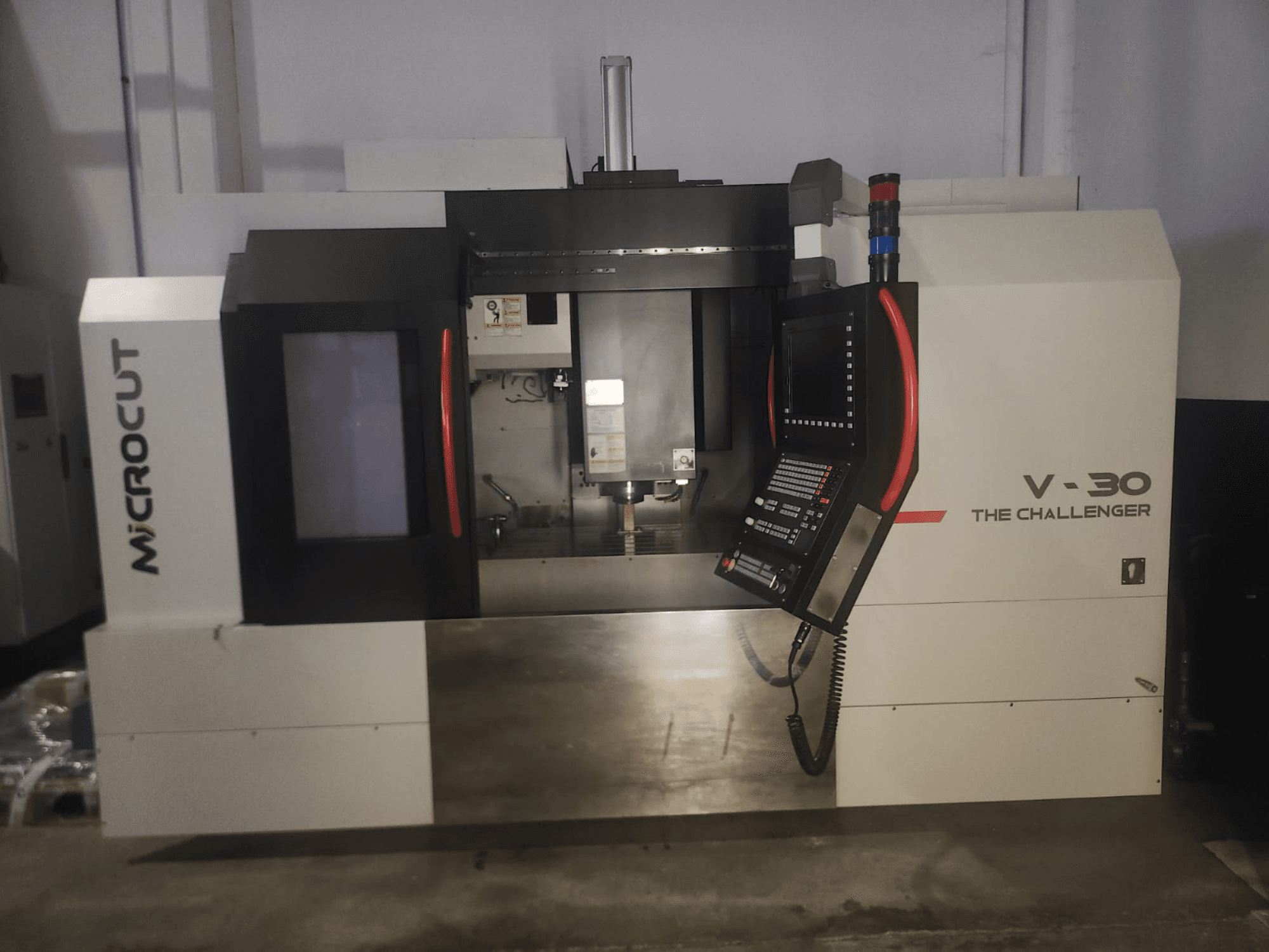 Microcut V-30 The Challenger CNC machine, front view, featuring control panel, cutting area, and industrial design elements.
